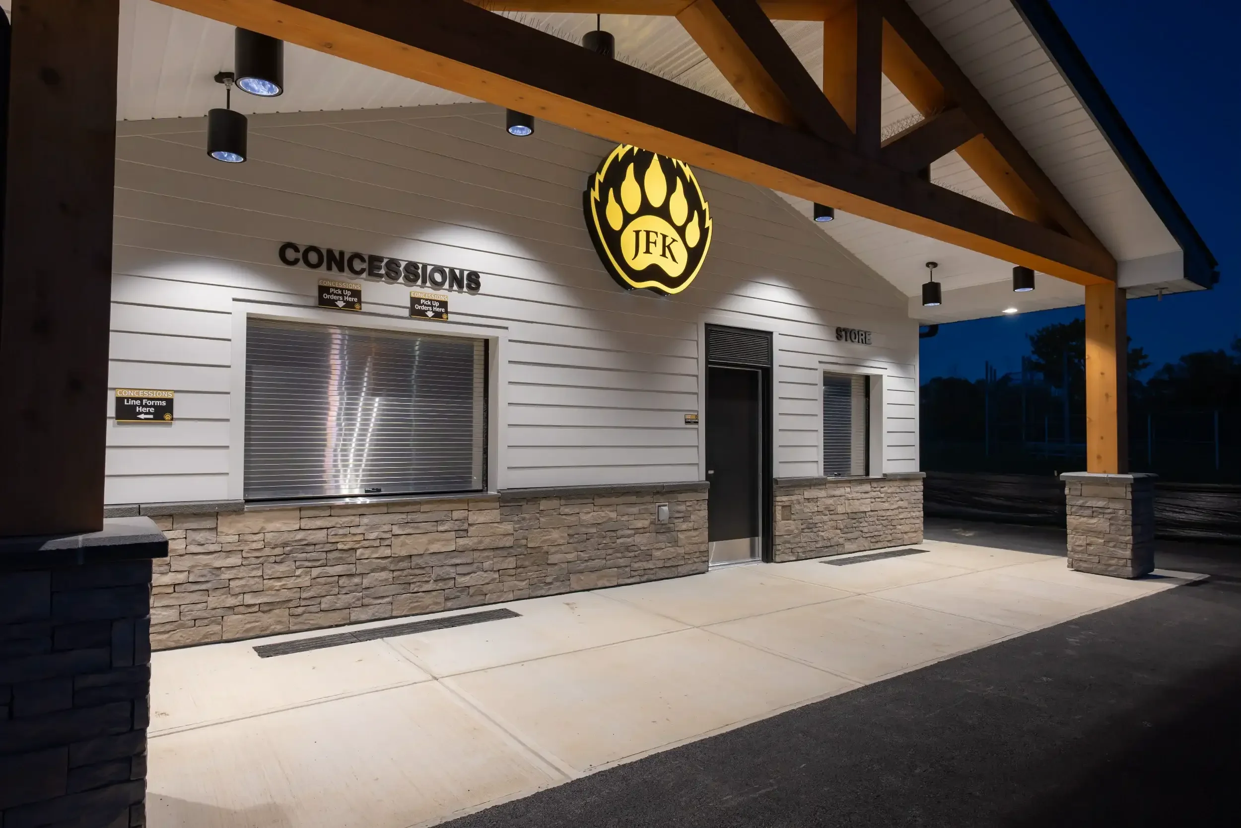 The exterior of a new concession stand, lit up at night, at Cheektowaga Sloan UFSD.