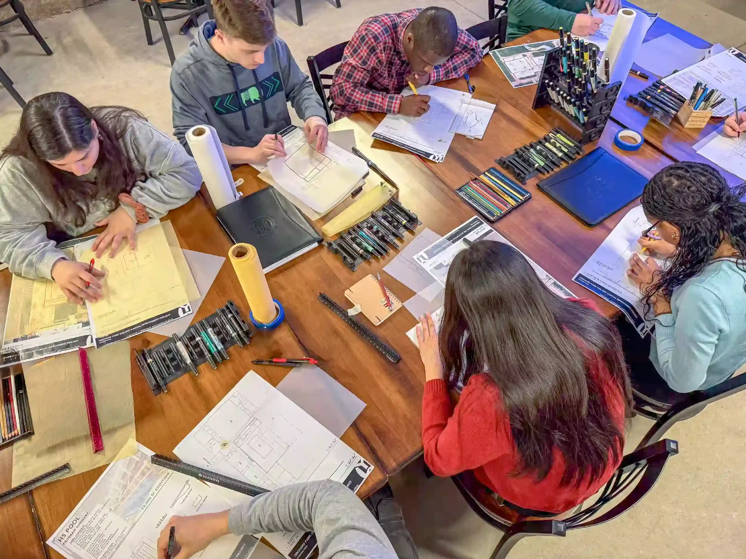 The interior design staff at Young + Wright Architectural working together on a project