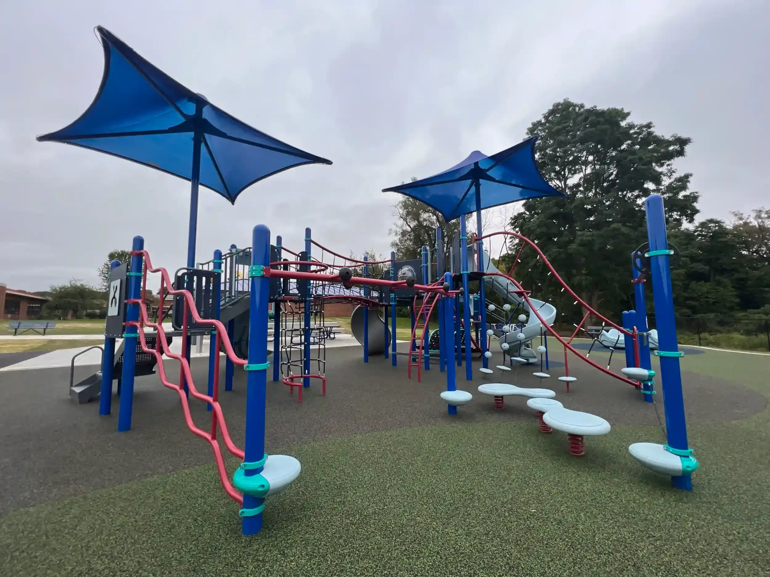 An upgraded playground showing shade and climbing structures