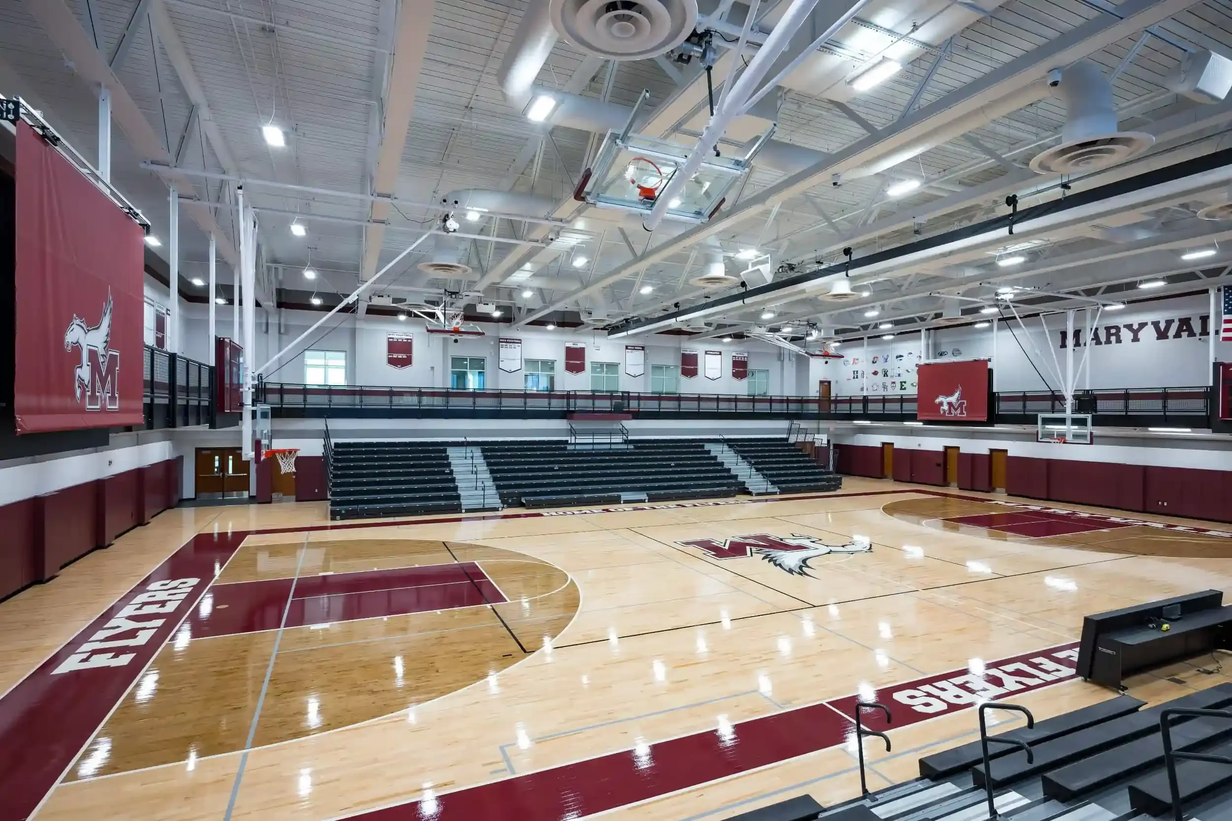A view of the new gymnasium, with the school's maroon colors in the foreground