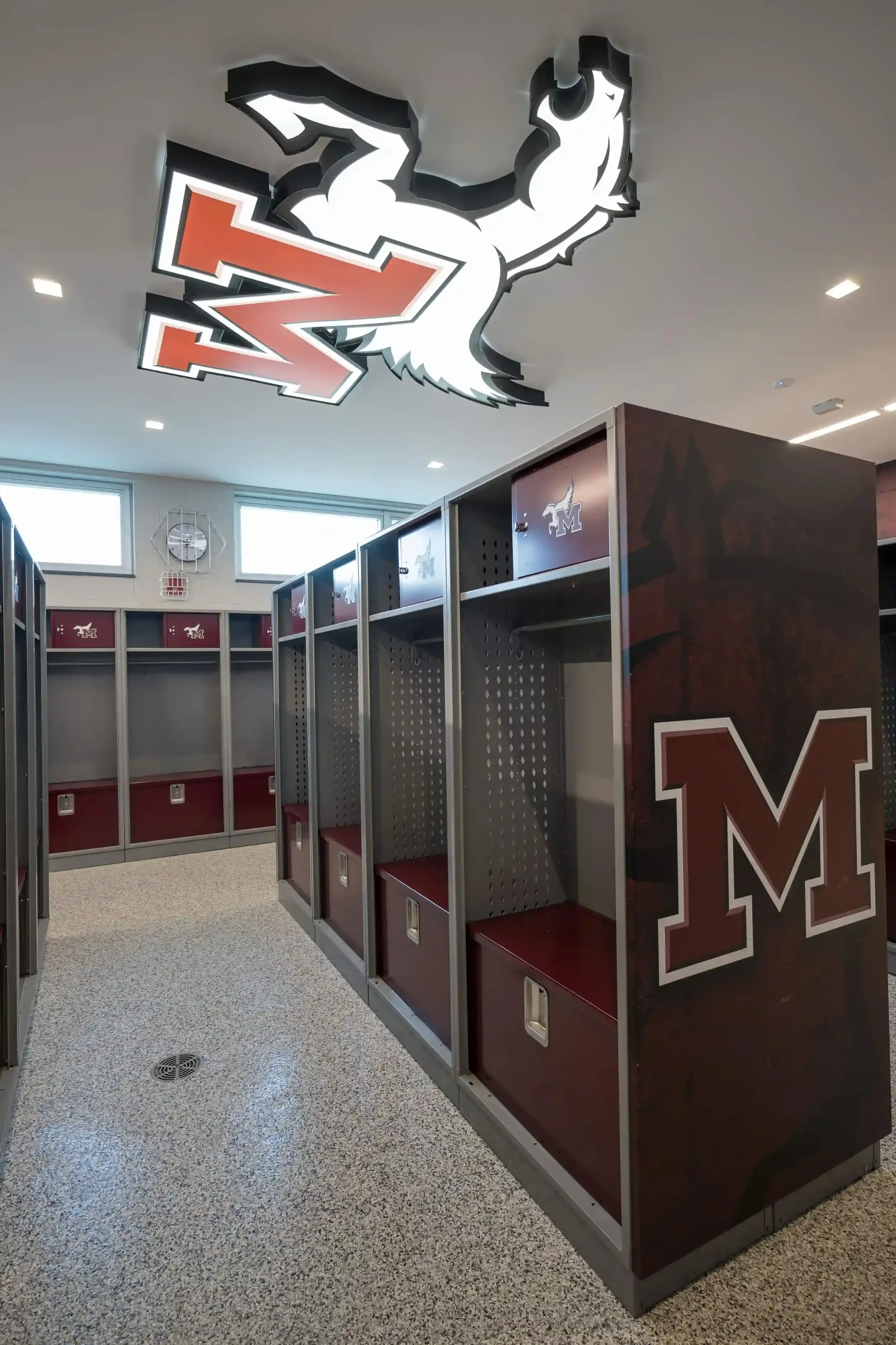 A view of the new locker room with the school's logo on the ceiling