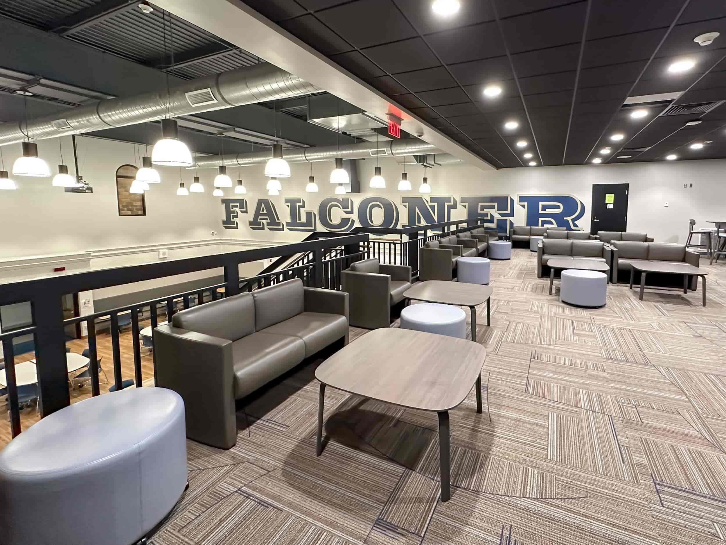 The upstairs cafeteria and socializing space with the school's name in large block letters on one wall
