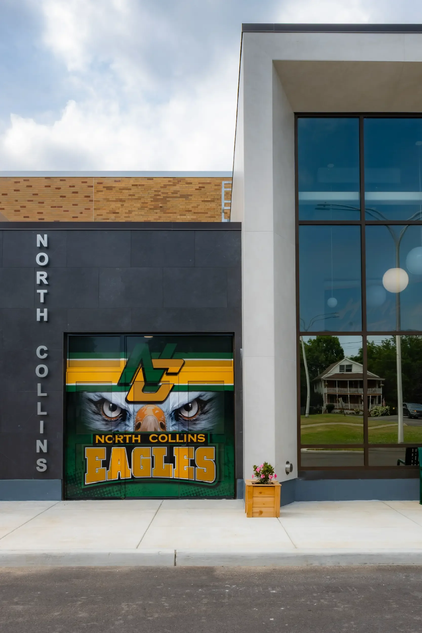 The athletic entry exterior at North Collins CSD with the school's logo prominently featured