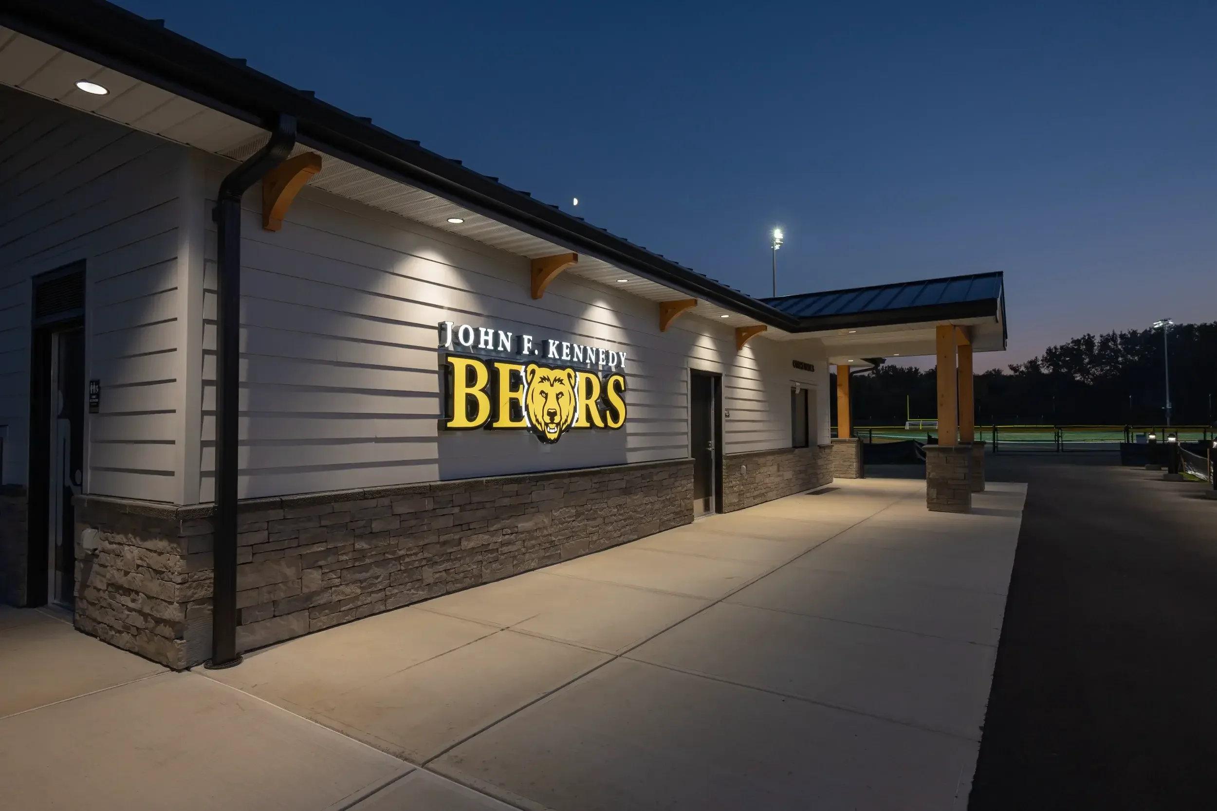 The exterior of a new concession stand, lit up at night, at Cheektowaga Sloan UFSD.