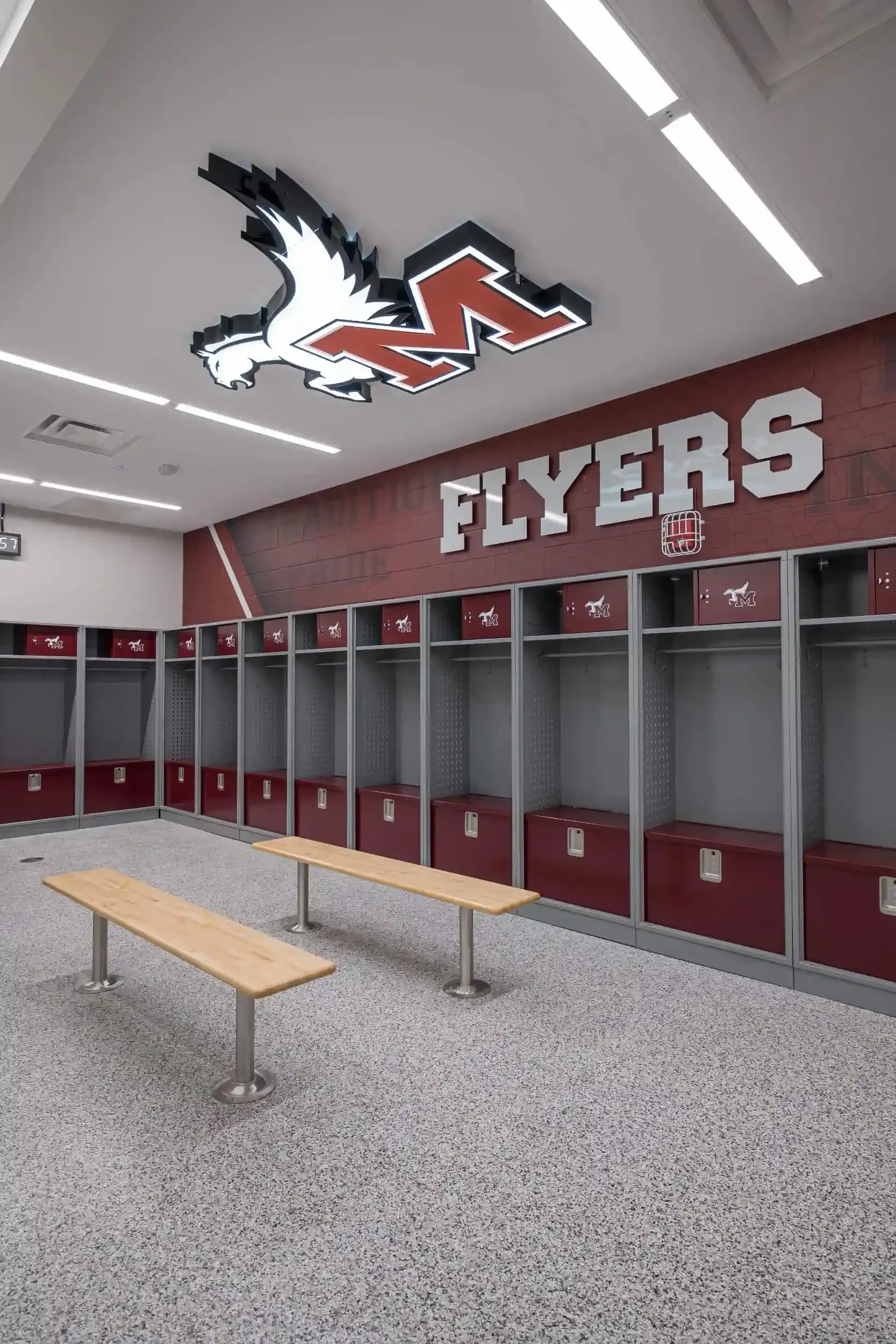 A view of the new locker room with the school's logo on the ceiling