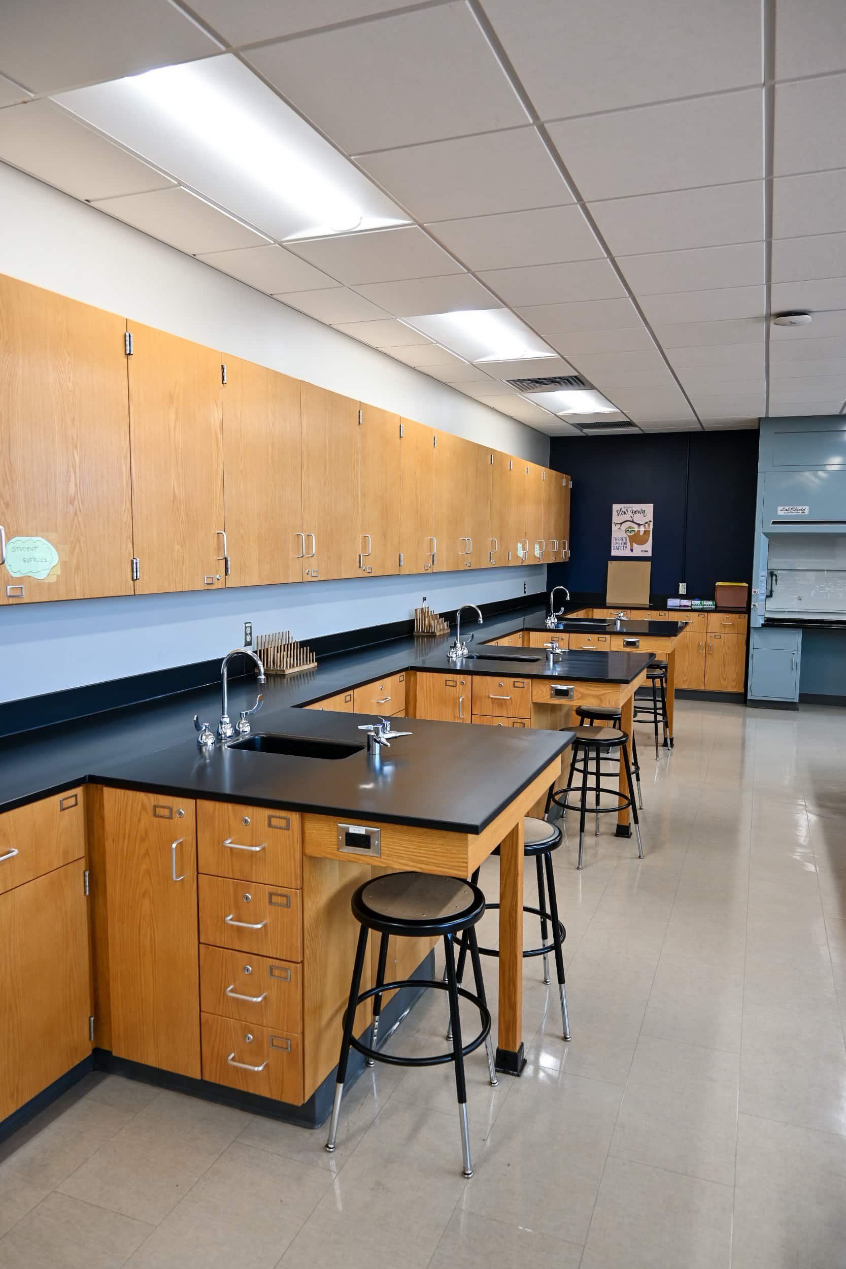 A classroom with stool seating and sink stations