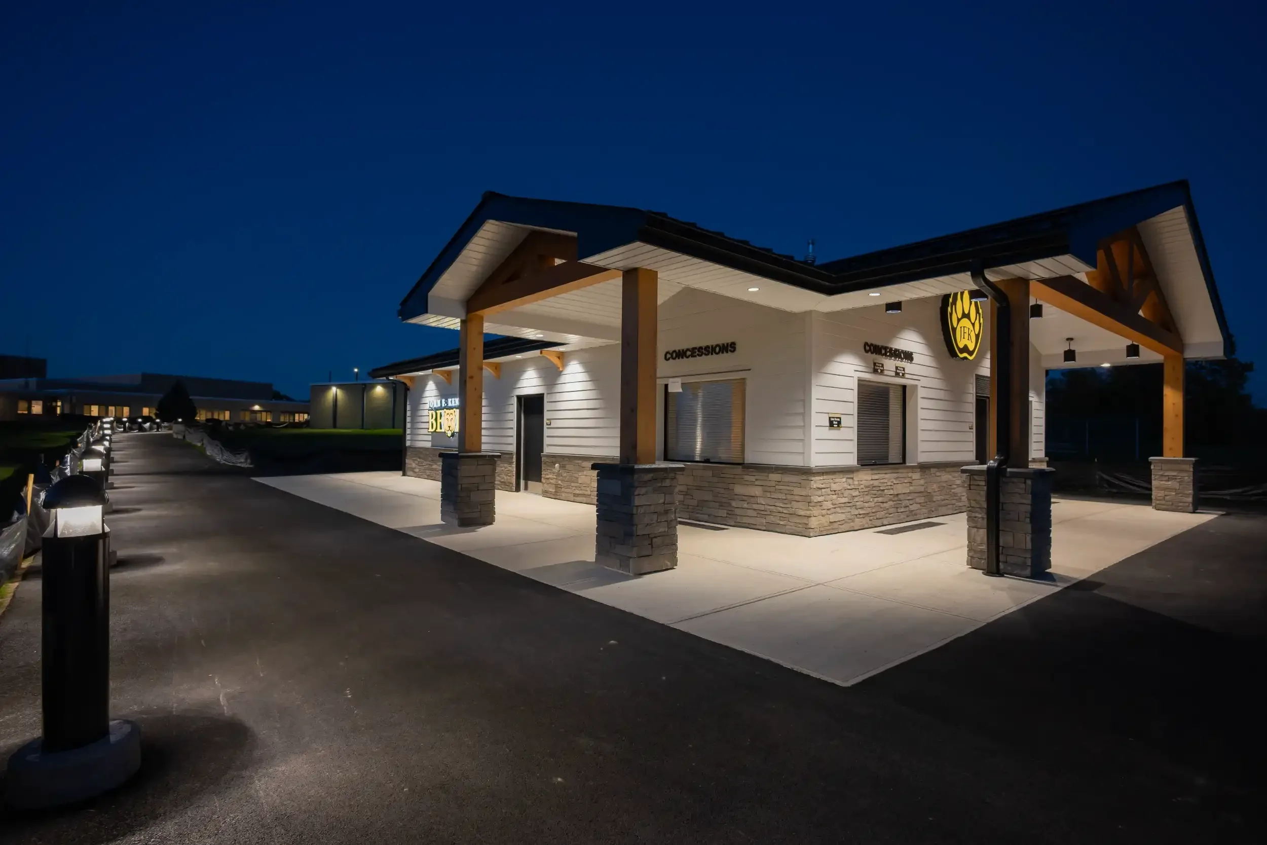 The exterior of a new concession stand, lit up at night, at Cheektowaga Sloan UFSD.