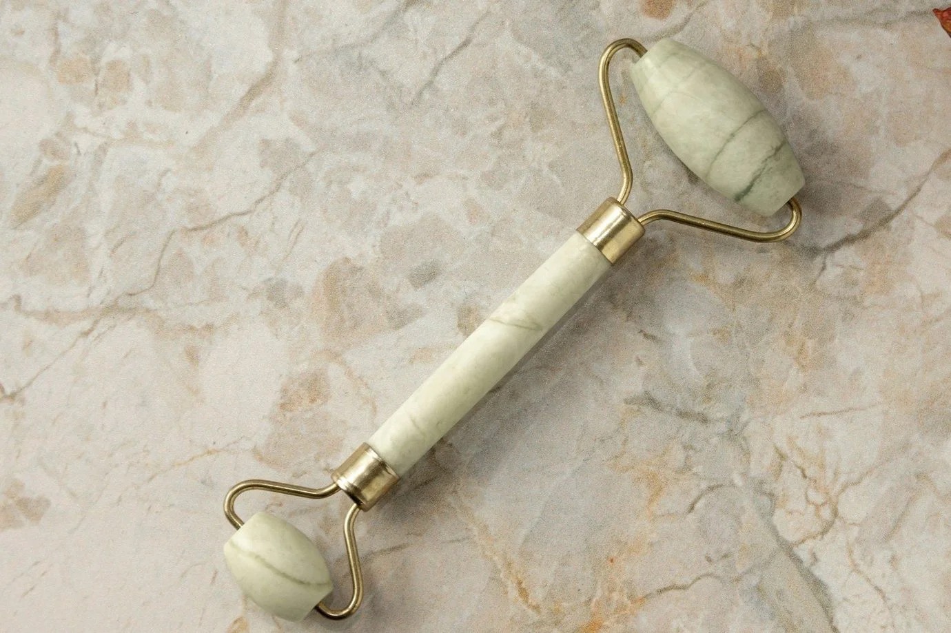 Green jade roller for facial massage, reducing puffiness, improving blood circulation, and enhancing skin glow