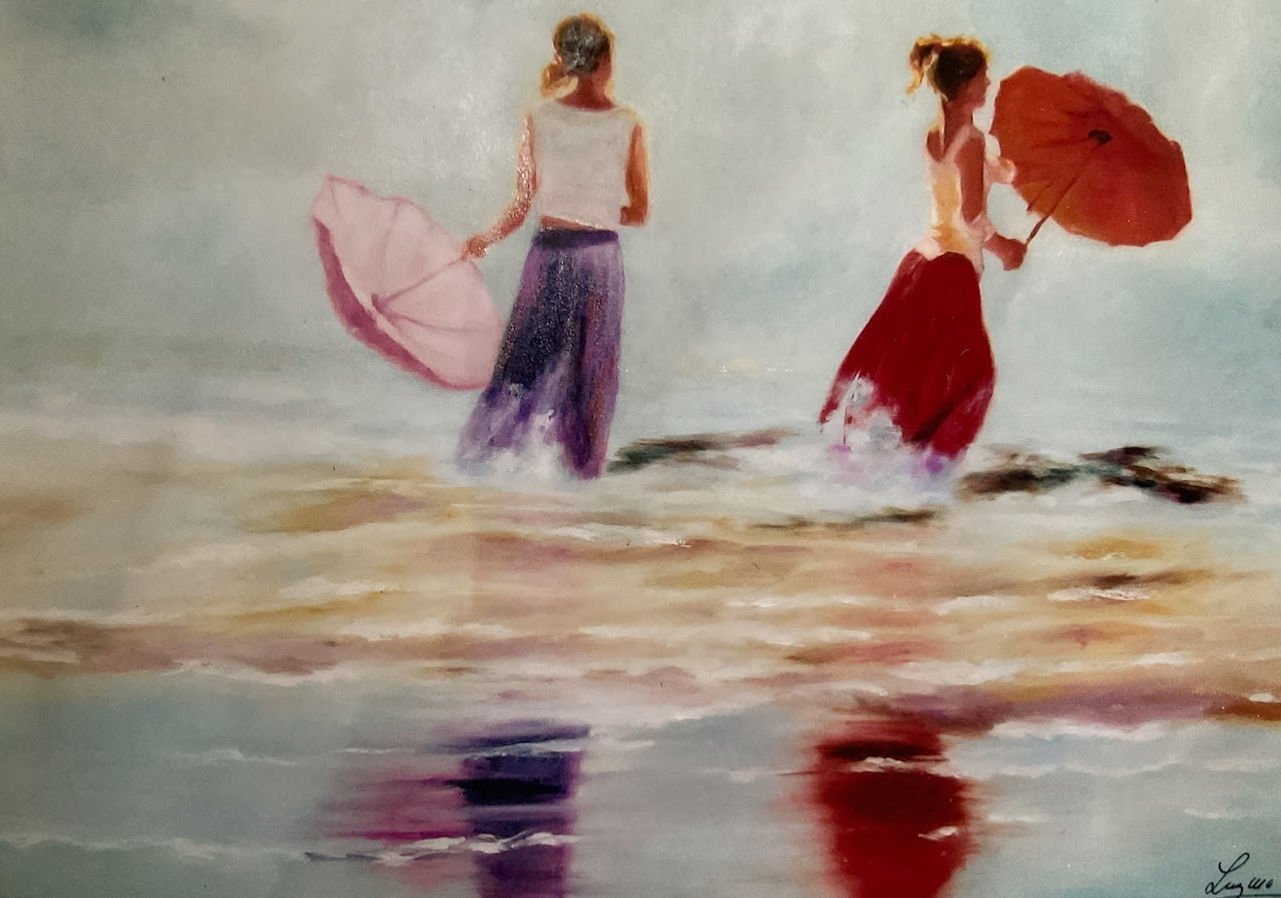 Two women holding umbrellas, walking along the beach in flowing skirts, reflected in the water.