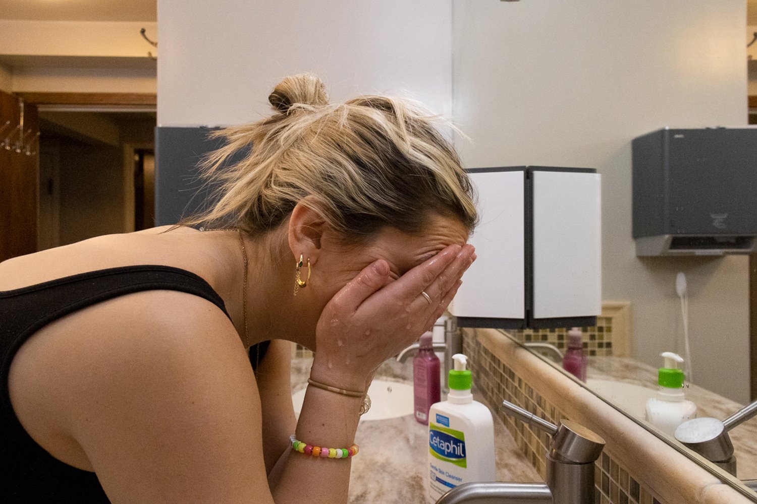 As the water drips down her face, Lindsay Best takes off her makeup for the night with someone else’s face wash. Generation z spends more than any other generation on skin care practices. Photo by Meredith Gamet.