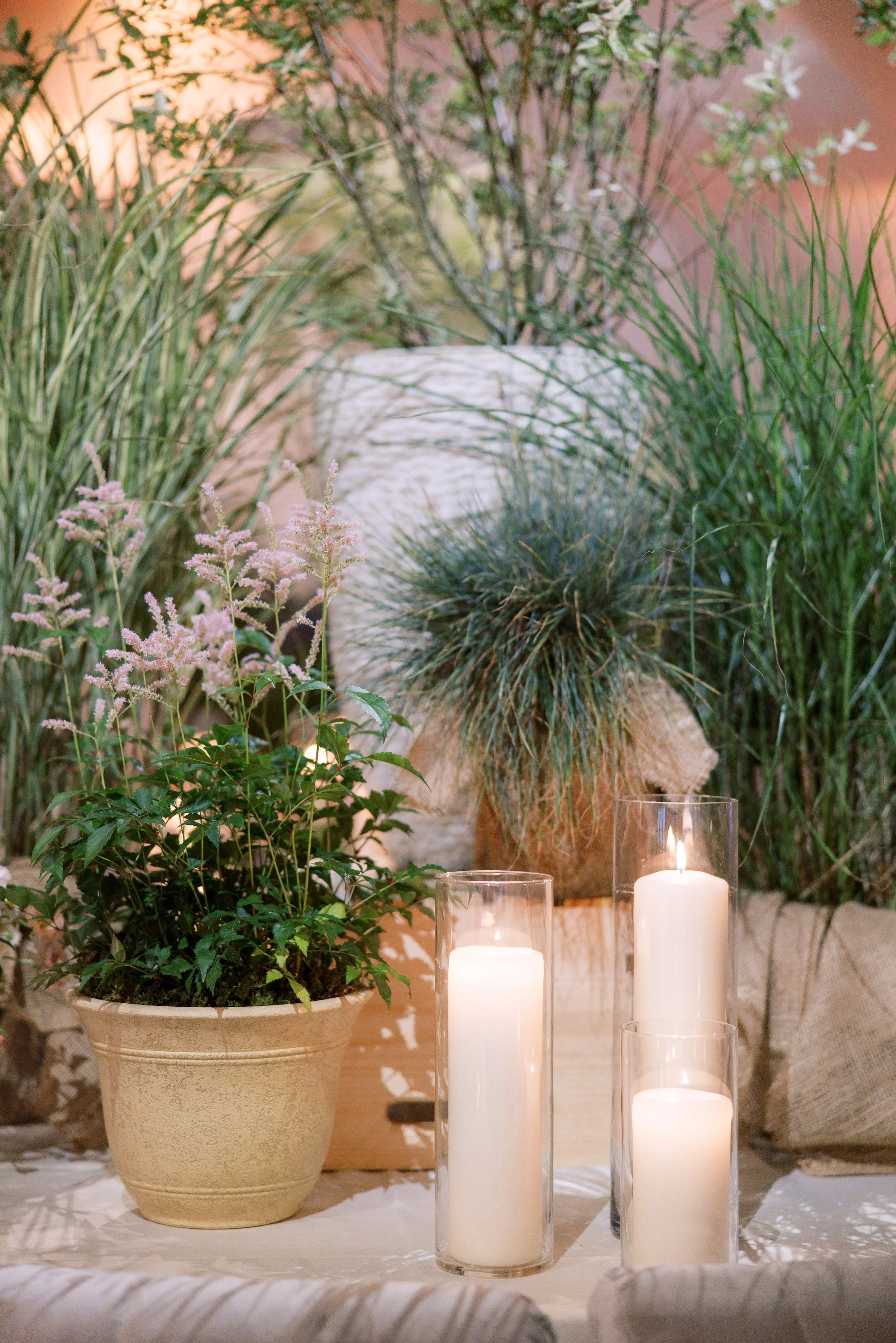 Reception setup with round tables, bentwood chairs, and lush greenery transforming the Altman Building into a backyard-inspired wedding in Chelsea NYC.