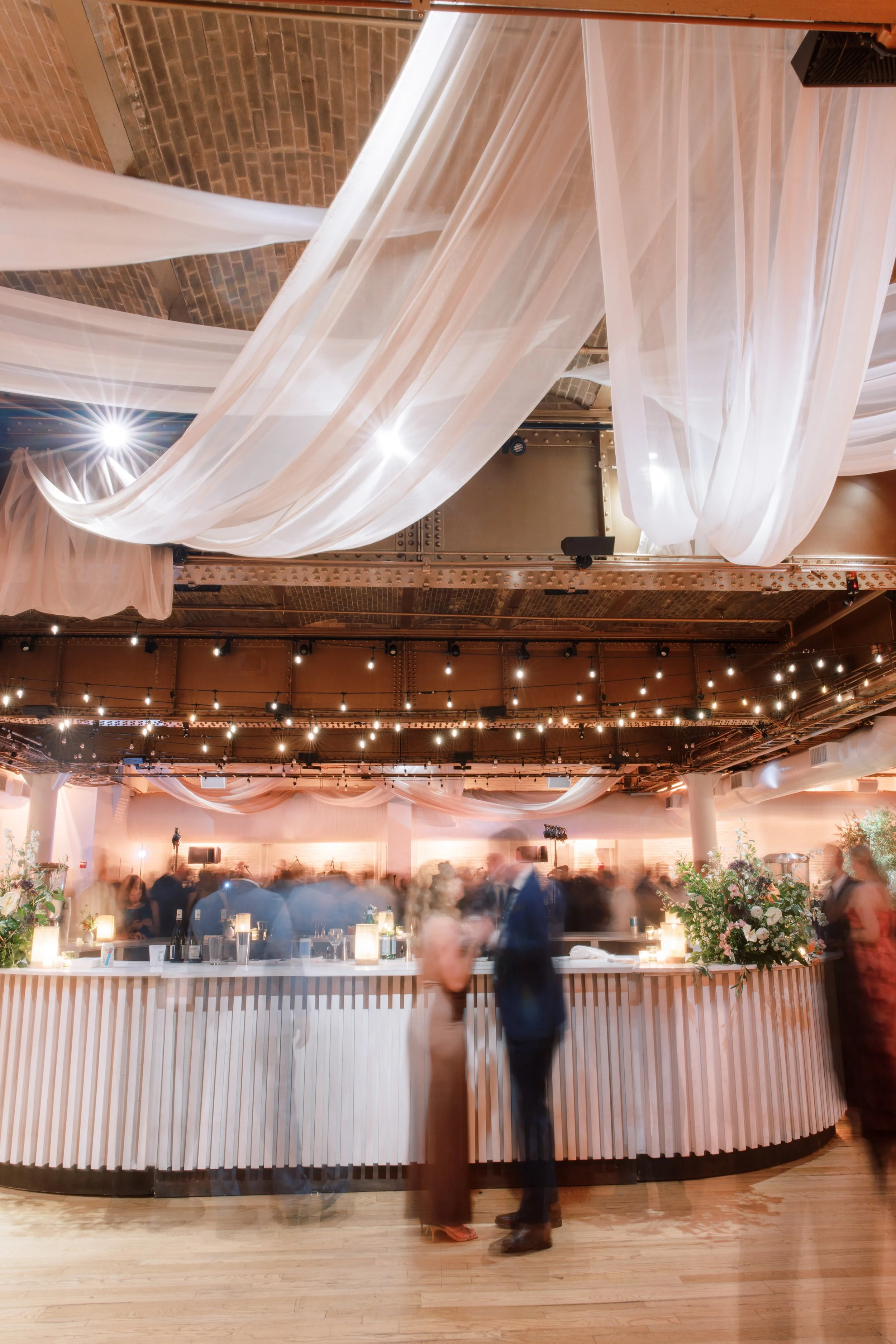 Guests celebrating on a packed dance floor during a Chelsea NYC wedding reception at the Altman Building.