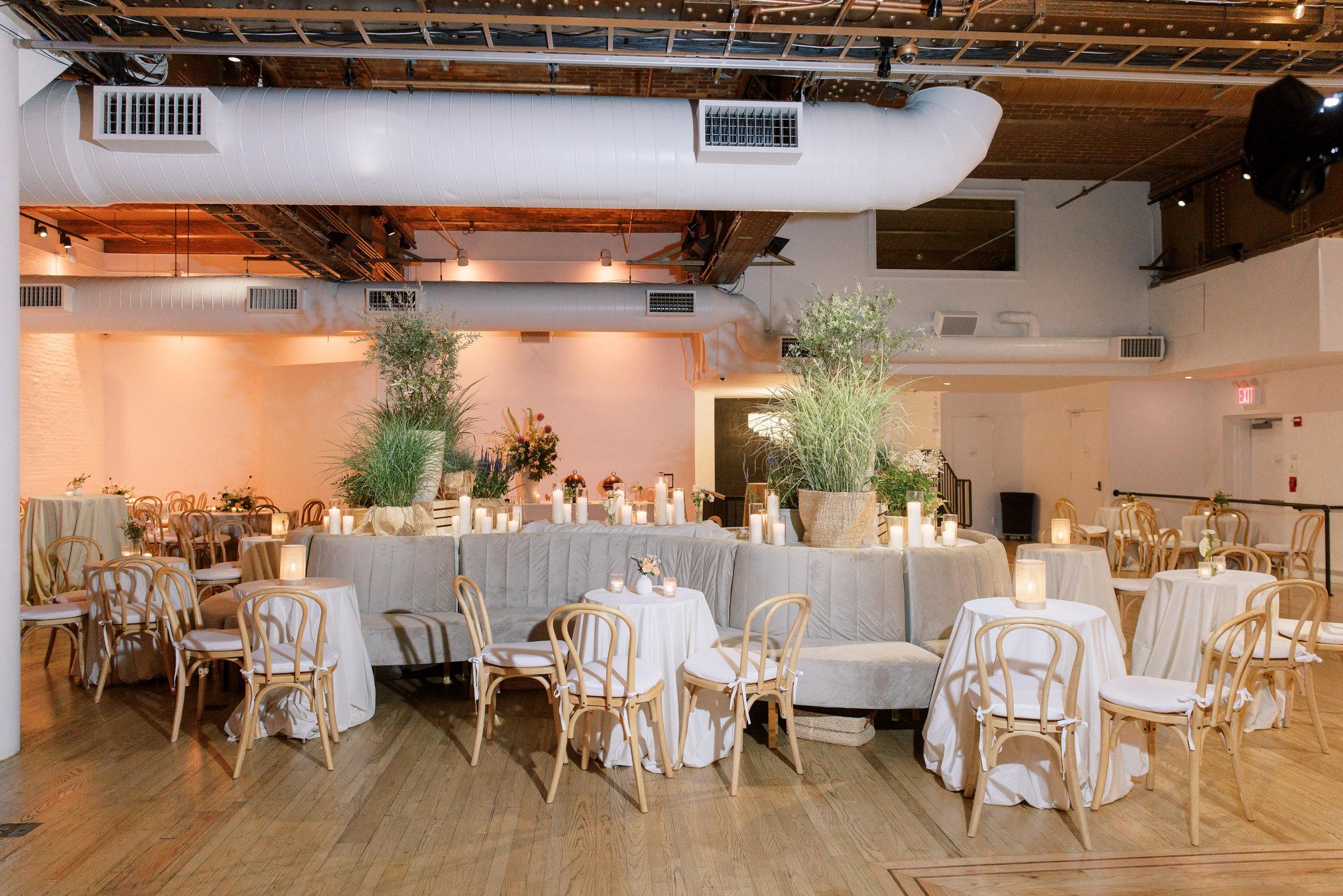 Intimate reception table with bentwood chairs and soft neutral florals inside the Altman Building in Chelsea NYC.