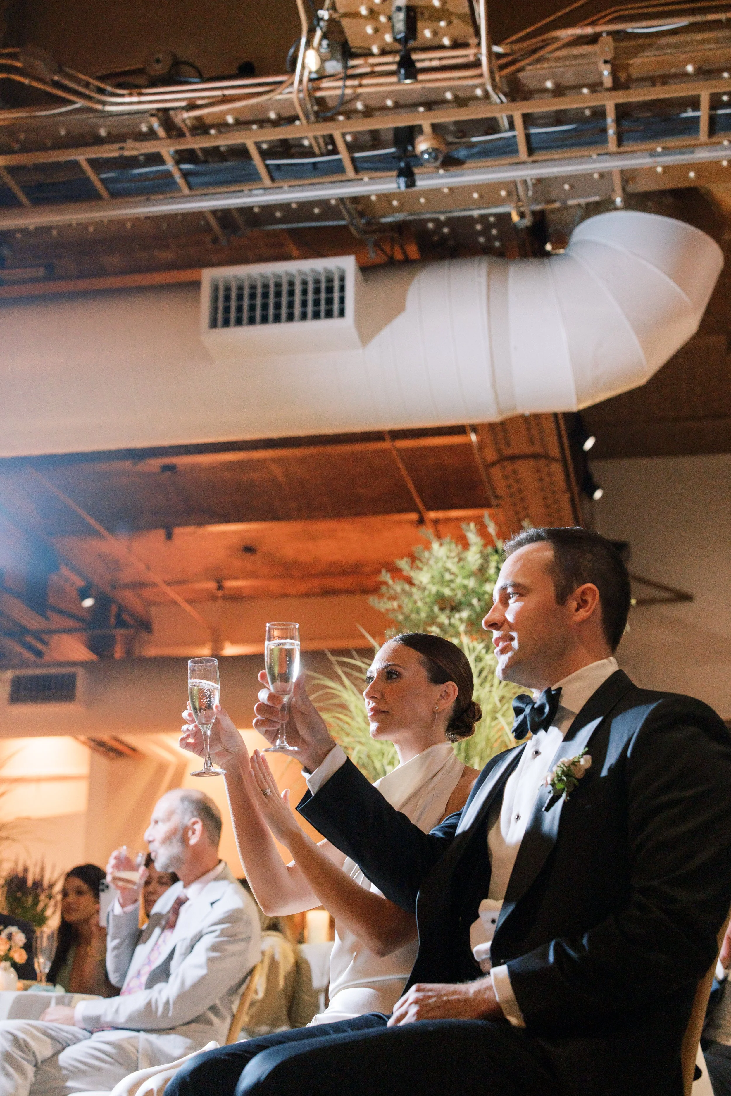 Bride and groom sharing a toast during their Chelsea NYC wedding reception at the Altman Building.