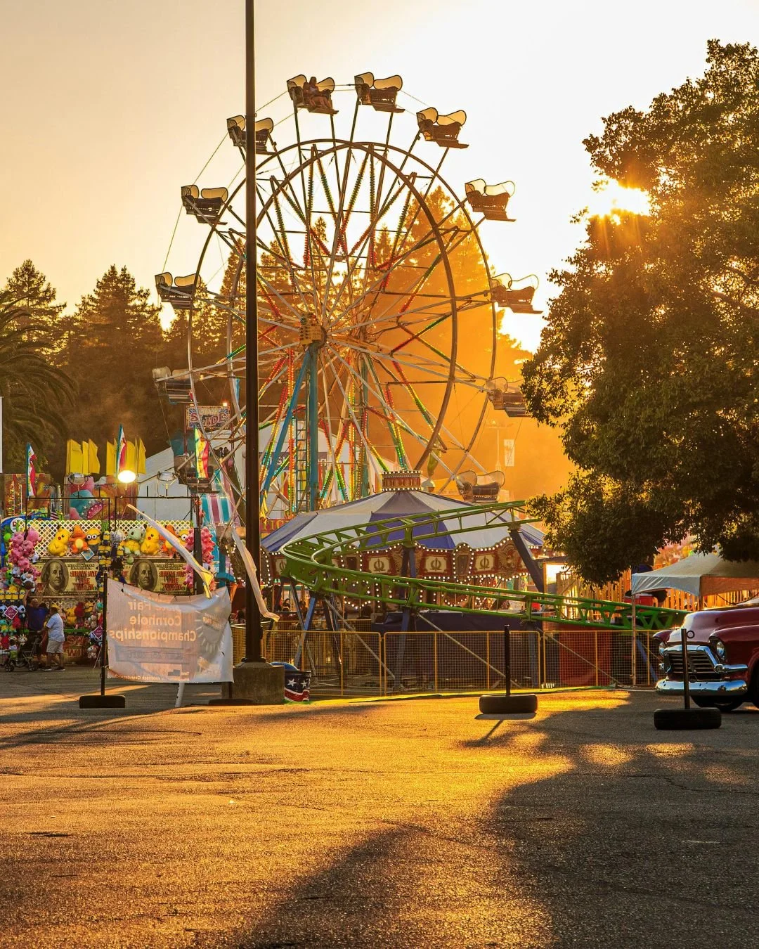 Ferris wheel and carnival rides at the El Dorado County Fair in Placerville CA at sunset.