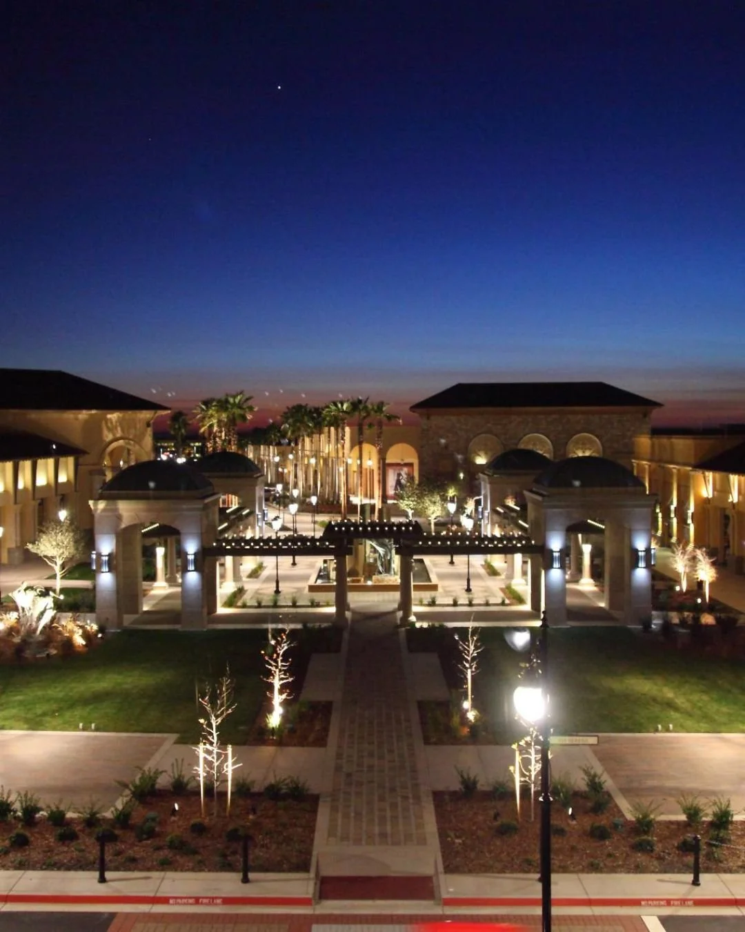 Night view of the Palladio shopping center in Folsom California with illuminated fountains, Italian-inspired architecture, and upscale dining and retail.