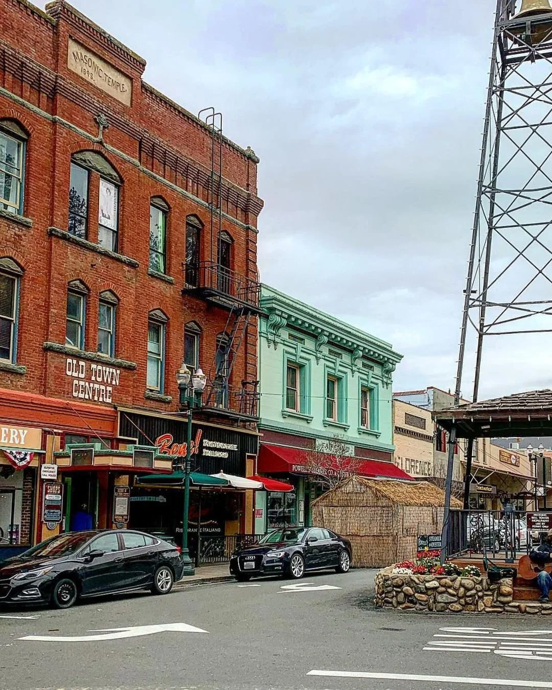 Historic downtown Placerville CA with Old Town Centre, Masonic Temple building, local shops, and iconic water tower on Main Street.