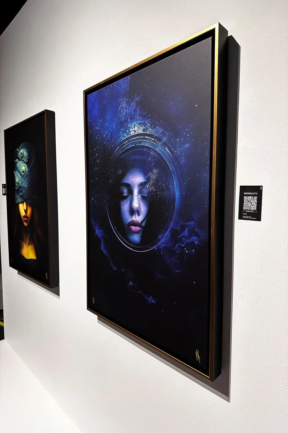 MADX Serenity and Justice of the Deep surreal fine art canvas prints displayed together at Nolcha Shows exhibition. Deep blue cosmic mixed-media artwork in gold float frames by NYC artist MADX.