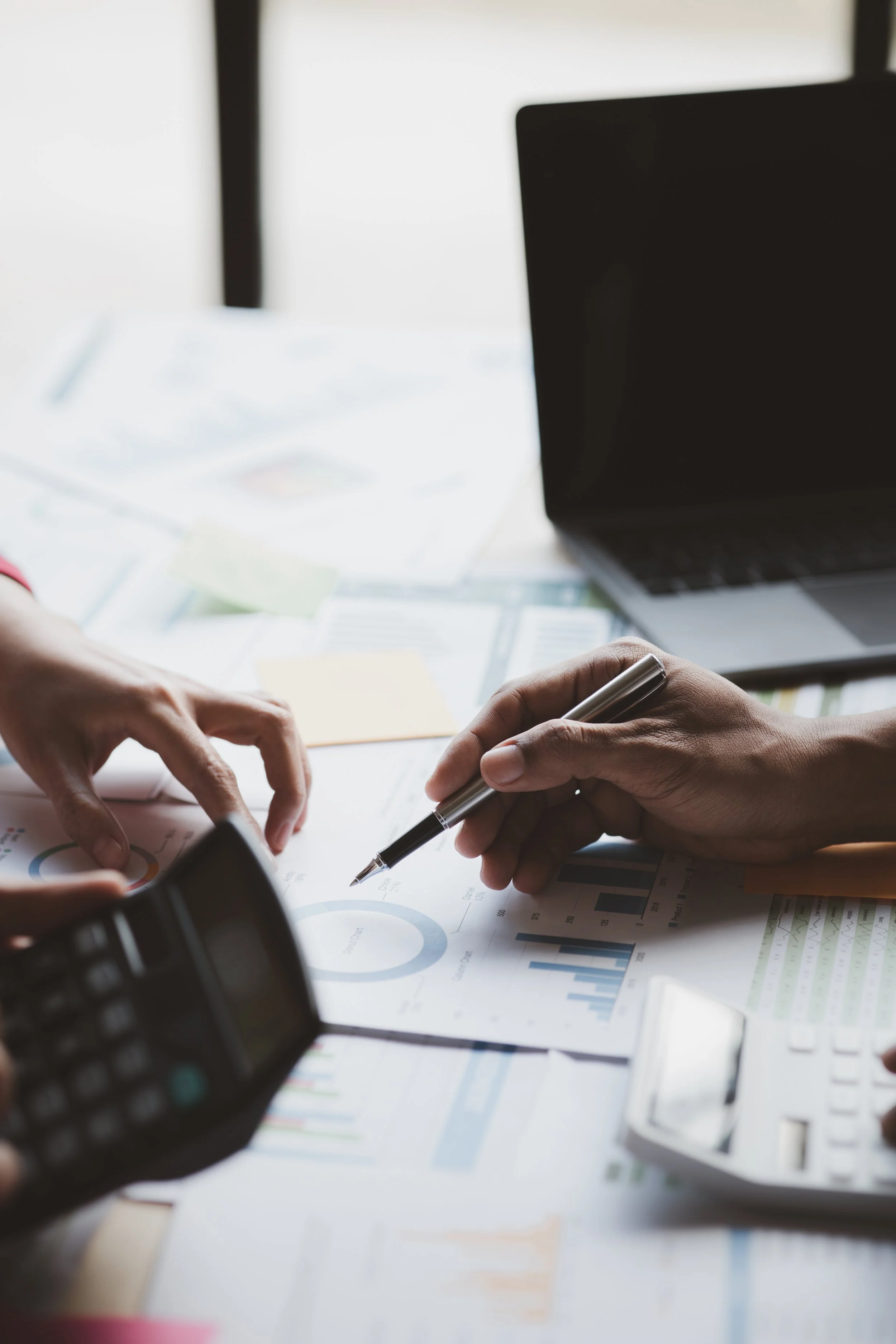 CPA reviewing financial charts and tax planning documents with a Toronto business owner