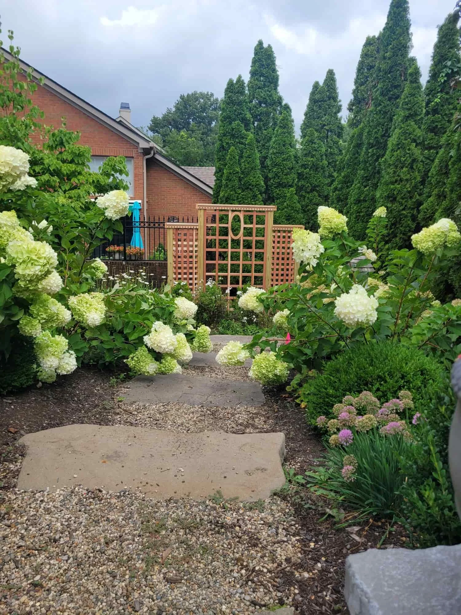 garden path that leads to a wooden trellis