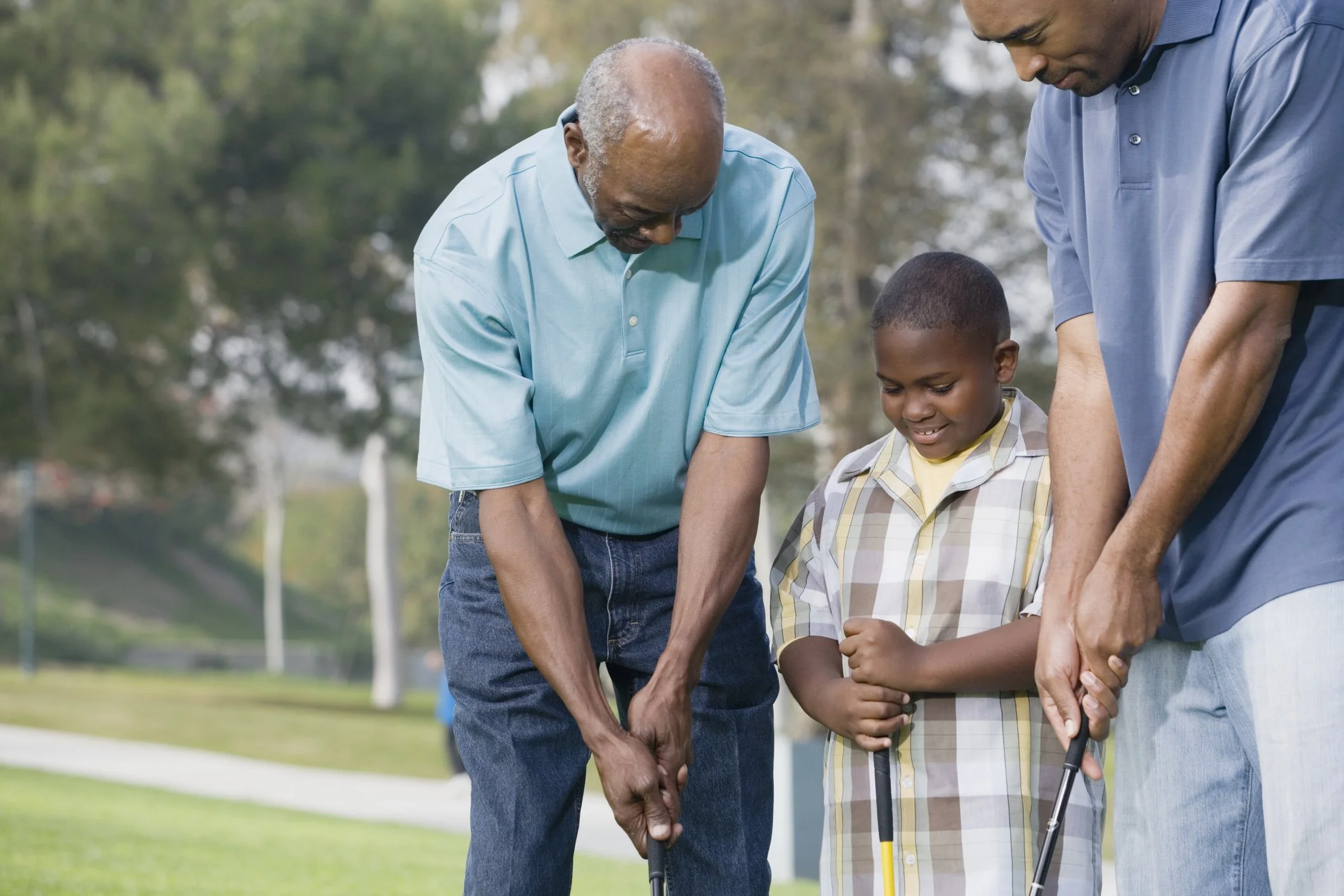 3 generations of men playing golf
