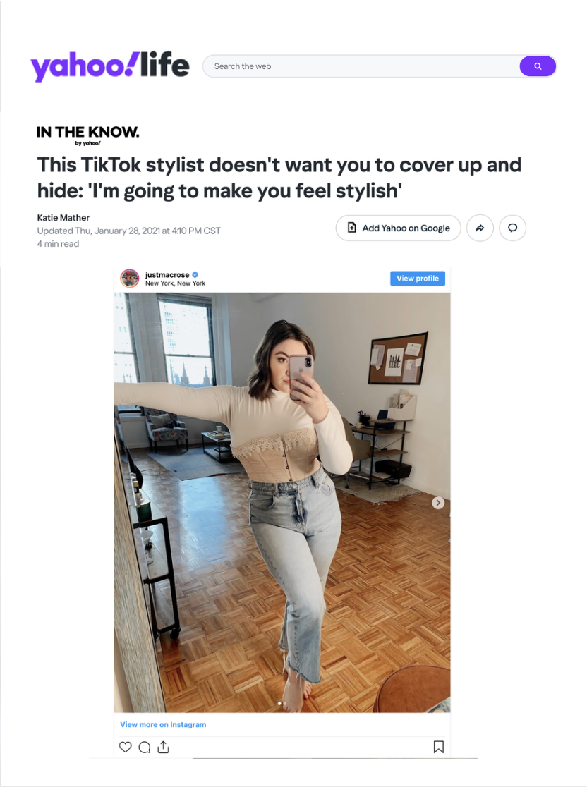 A woman in a colorful floral dress and high heels joyfully dancing and smiling inside a subway car, holding onto a vertical pole.