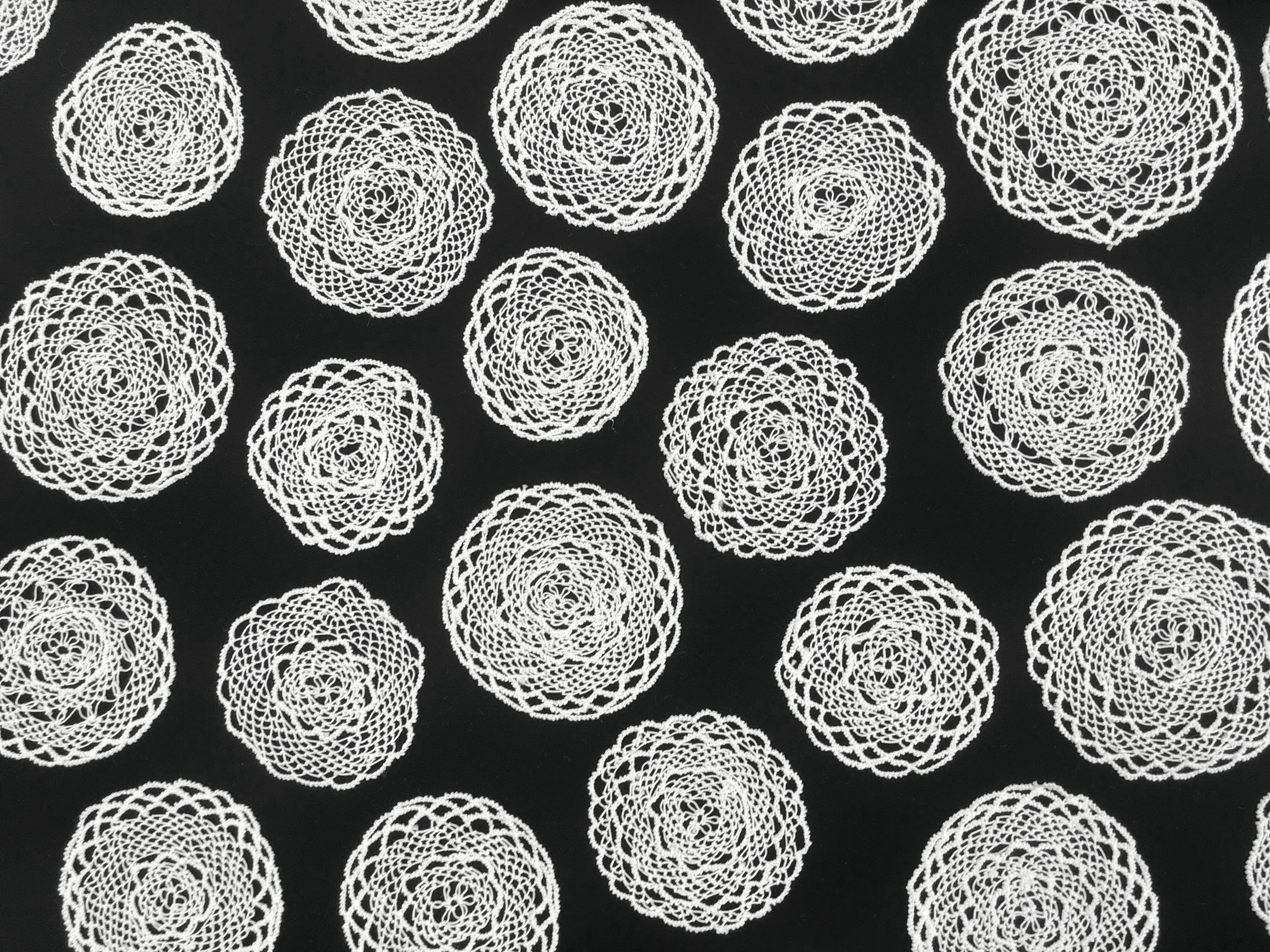 Black and white photo of several Armenian needlelace medallions