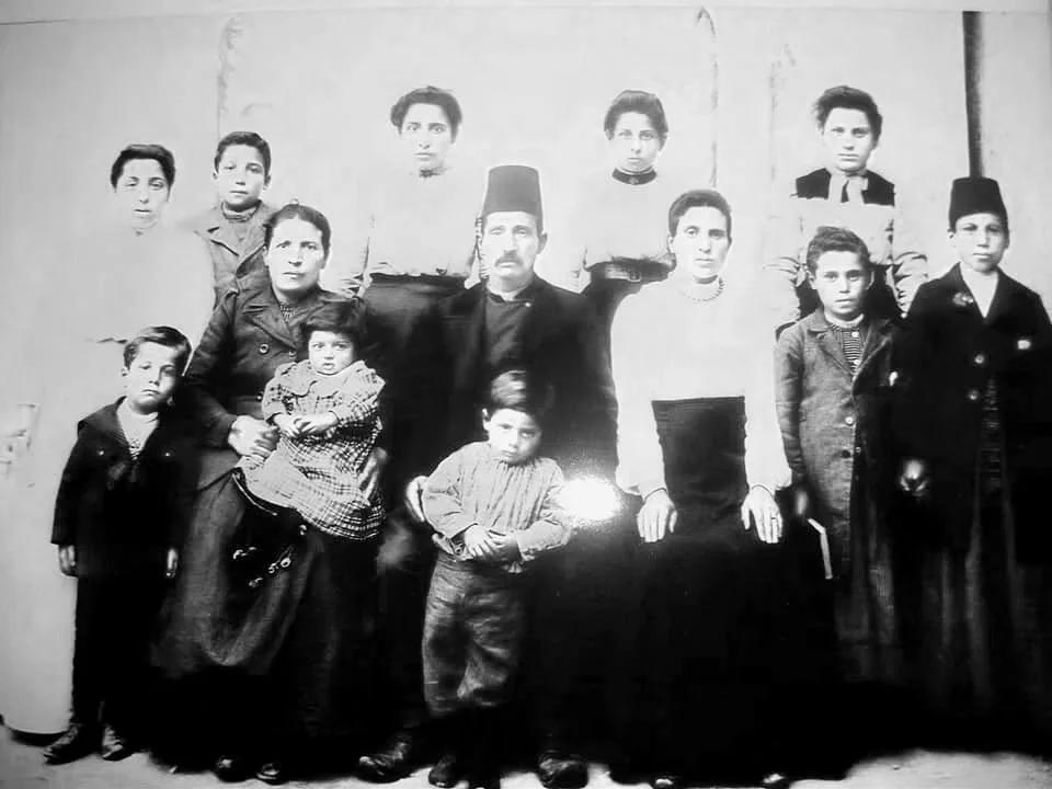 Satinig Chopoorian (standing far right) with her mother Anna Chopoorian (seated with white shirt next to her brother-in-law) and Satinig's two brothers (standing in front of Sating). Satinig did not survive the death march to Aleppo. Photograph court