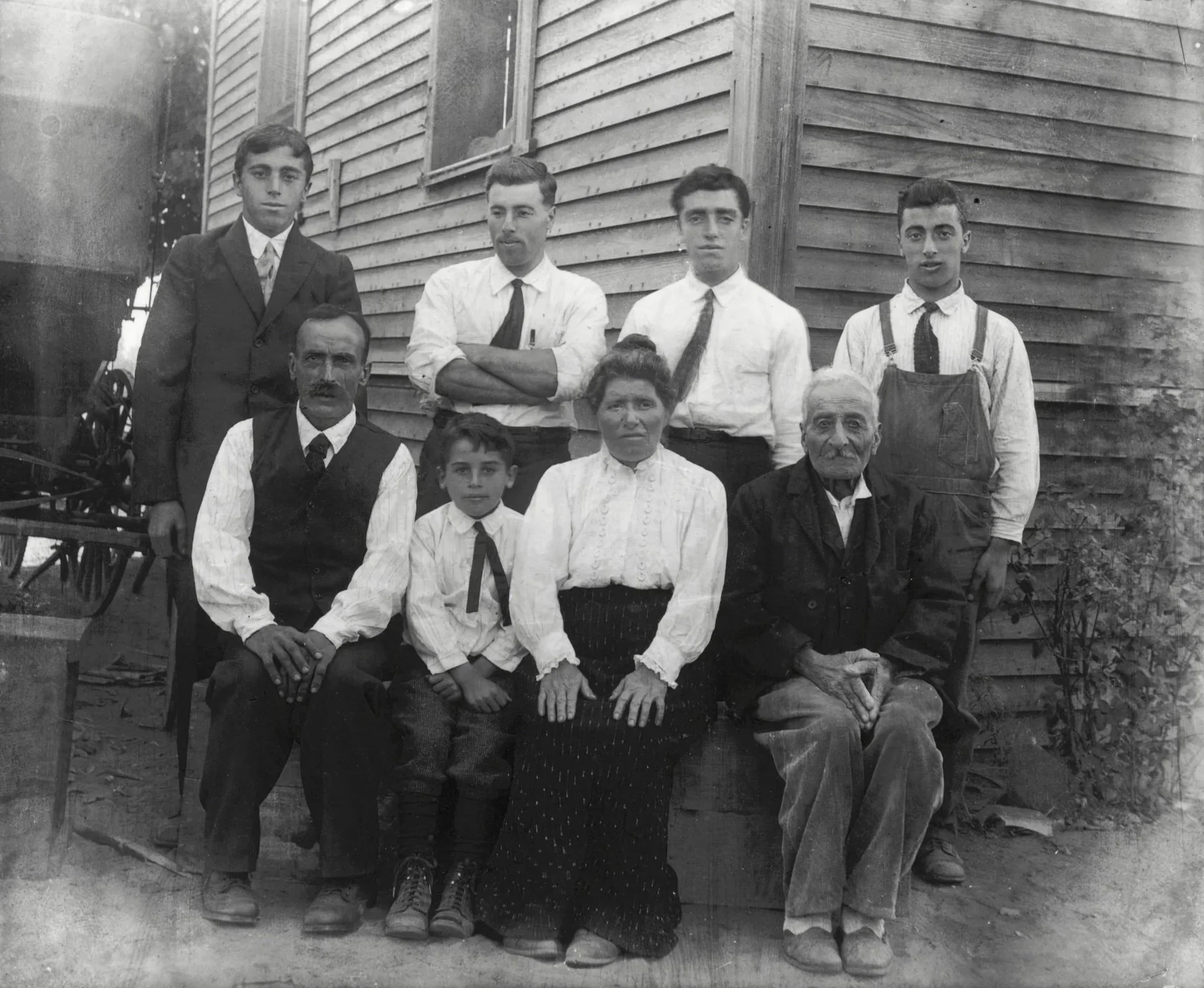 Magarian farm, Fresno Colony, California, ca. 1914. Yeghsapet Ashodian Magarian is seated in the center surrounded by her father (R), husband (L), and five sons. Deborah's grandfather Masick Magarian stands third from the left. Photo: © Deborah Valom