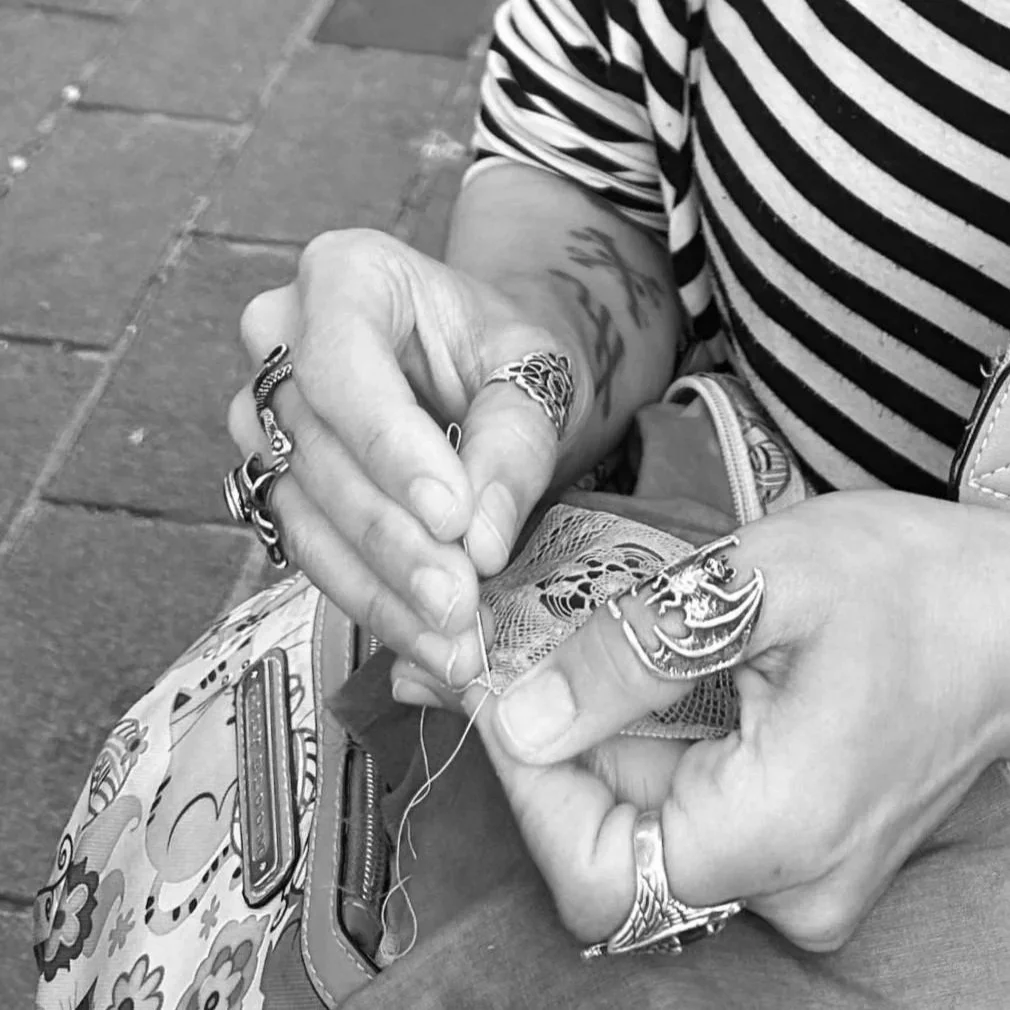 Black and white photo of person making Armenian needlelace