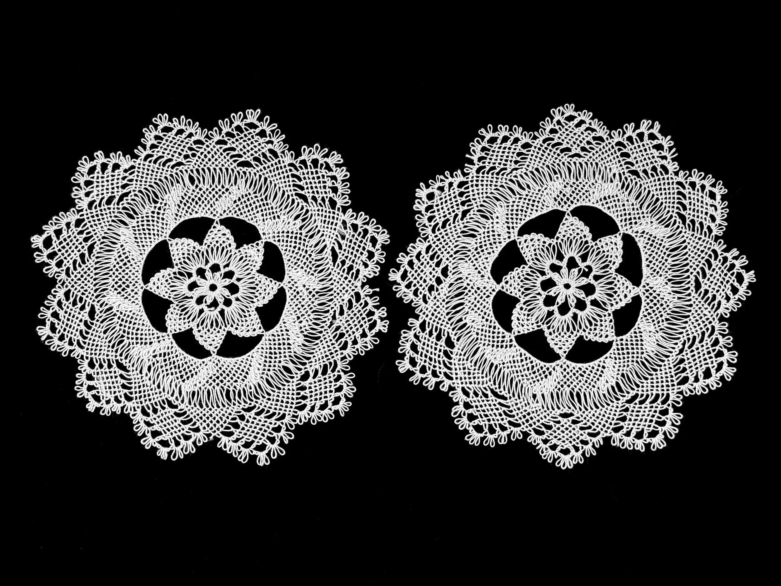 Black and white photo of twin Armenian needlelace doilies