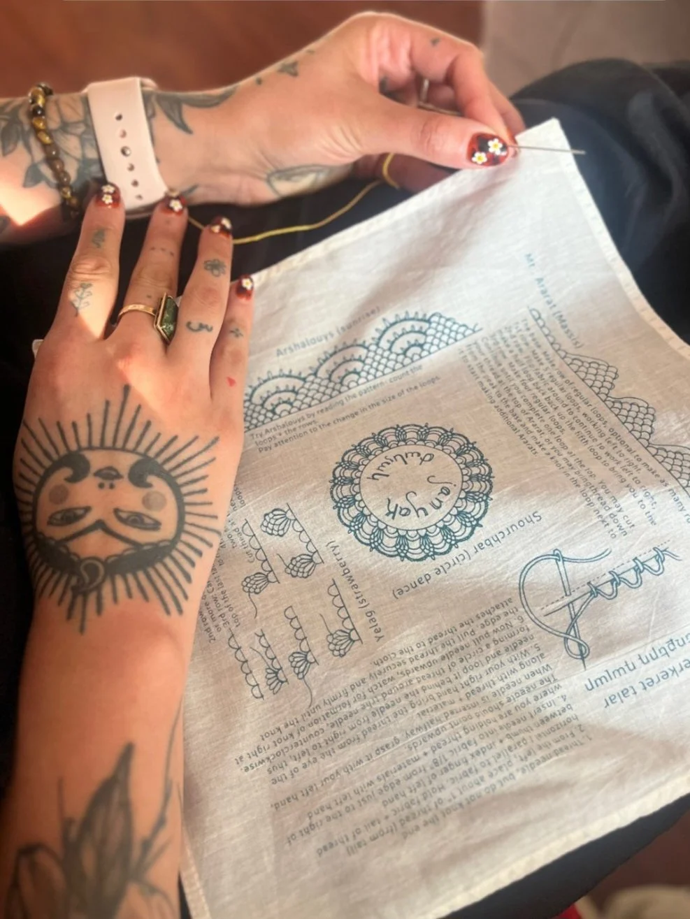 Ali Cat, screenprint on handkerchief, cotton fabric and linen thread, Portland, Oregon, 2025. Ali created the illustration and text to be used as an aid for their first janyak class, "Intro to Janyak," as part of the SWANA Stitch Workshop series at S