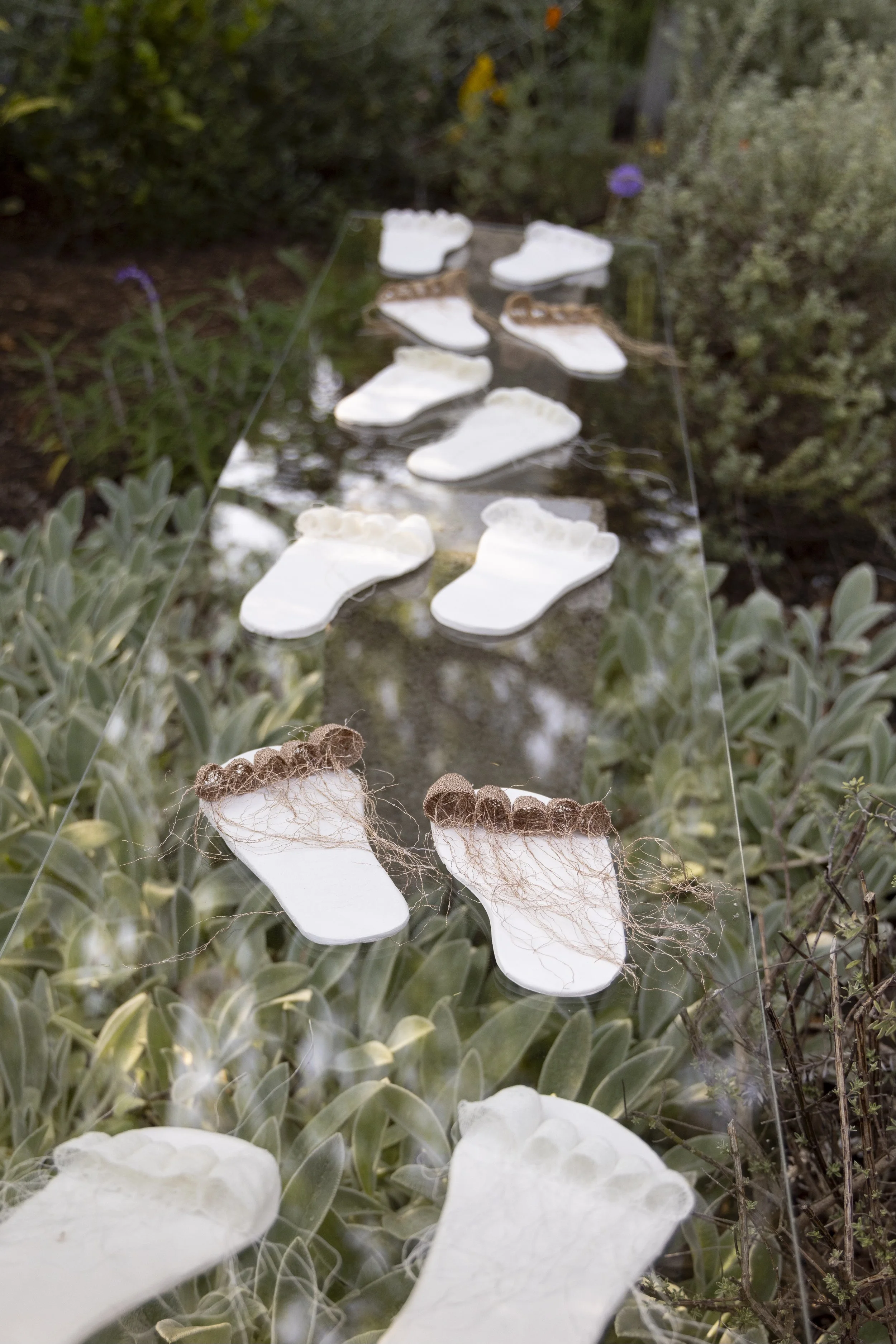 Ruzanna Hanesyan, lace sculpture of the artist's feet; plexiglass, clay, metallic and cotton thread; Pasadena, CA, 2024. Ruzanna notes: "the footprints suggest a journey or migration, exploration of identity, memory, and the connection to home." Firs