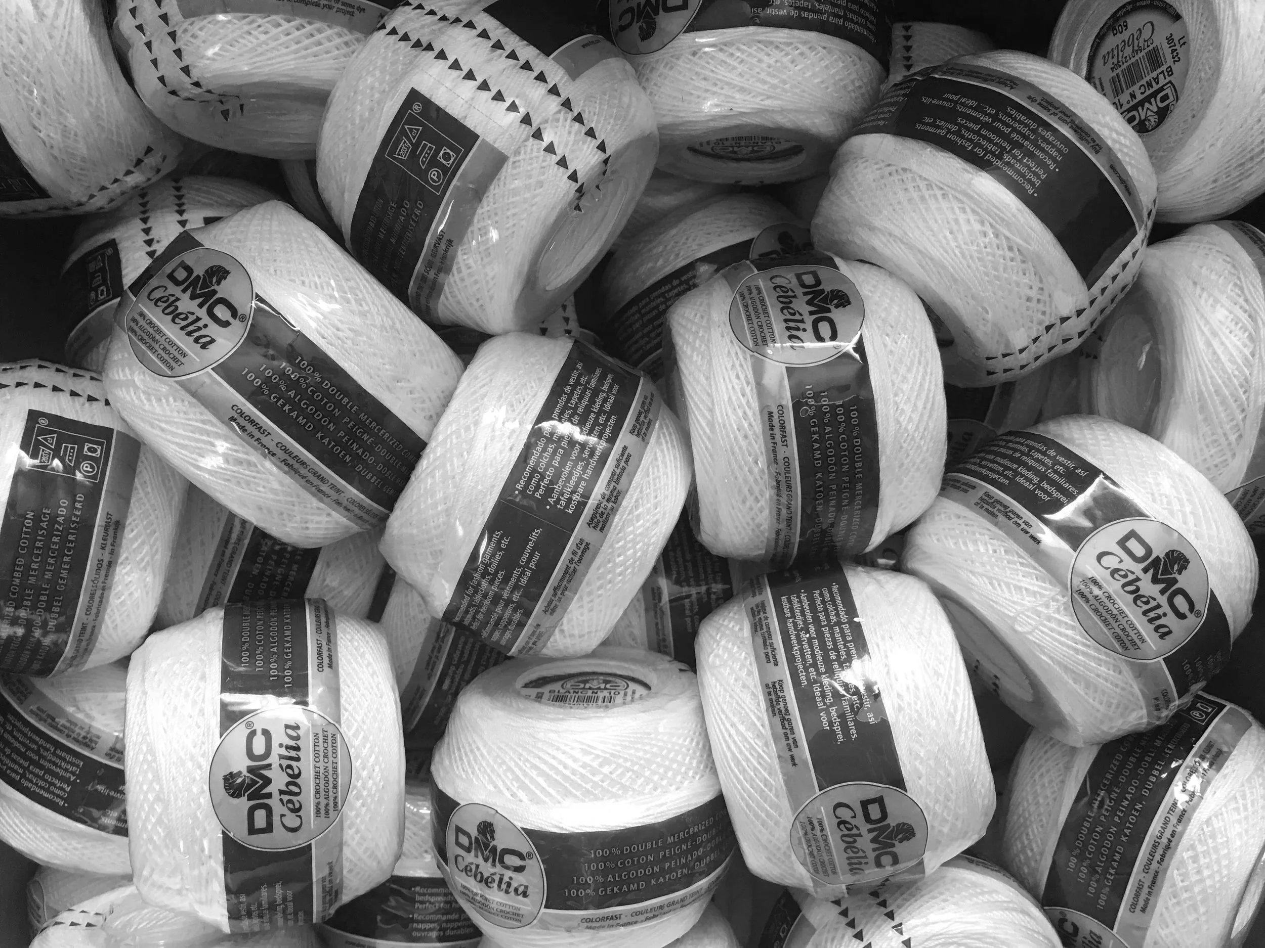 Black and white photo of balls of thread