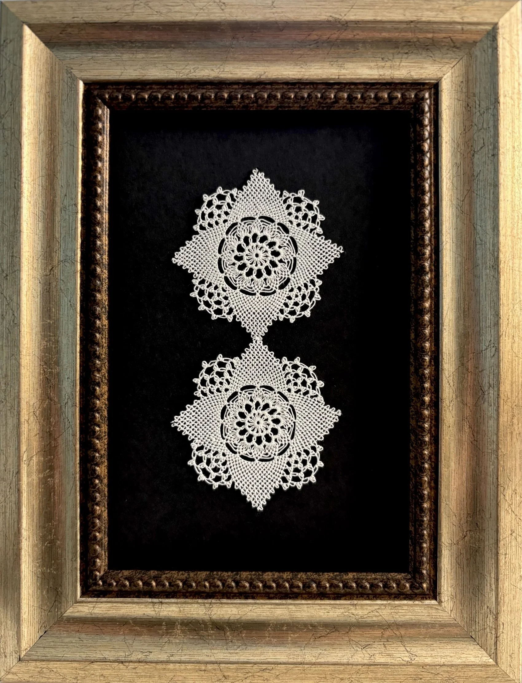Mikayla Kurkjian,  My Grandmother Before Me , two small doilies mounted and framed, Maryland, 2025. A replication of Mikayla's grandmother's work, this piece was featured in "Threadlines," the 2025 SWANA Stitch group show for Portland Textile Month. 