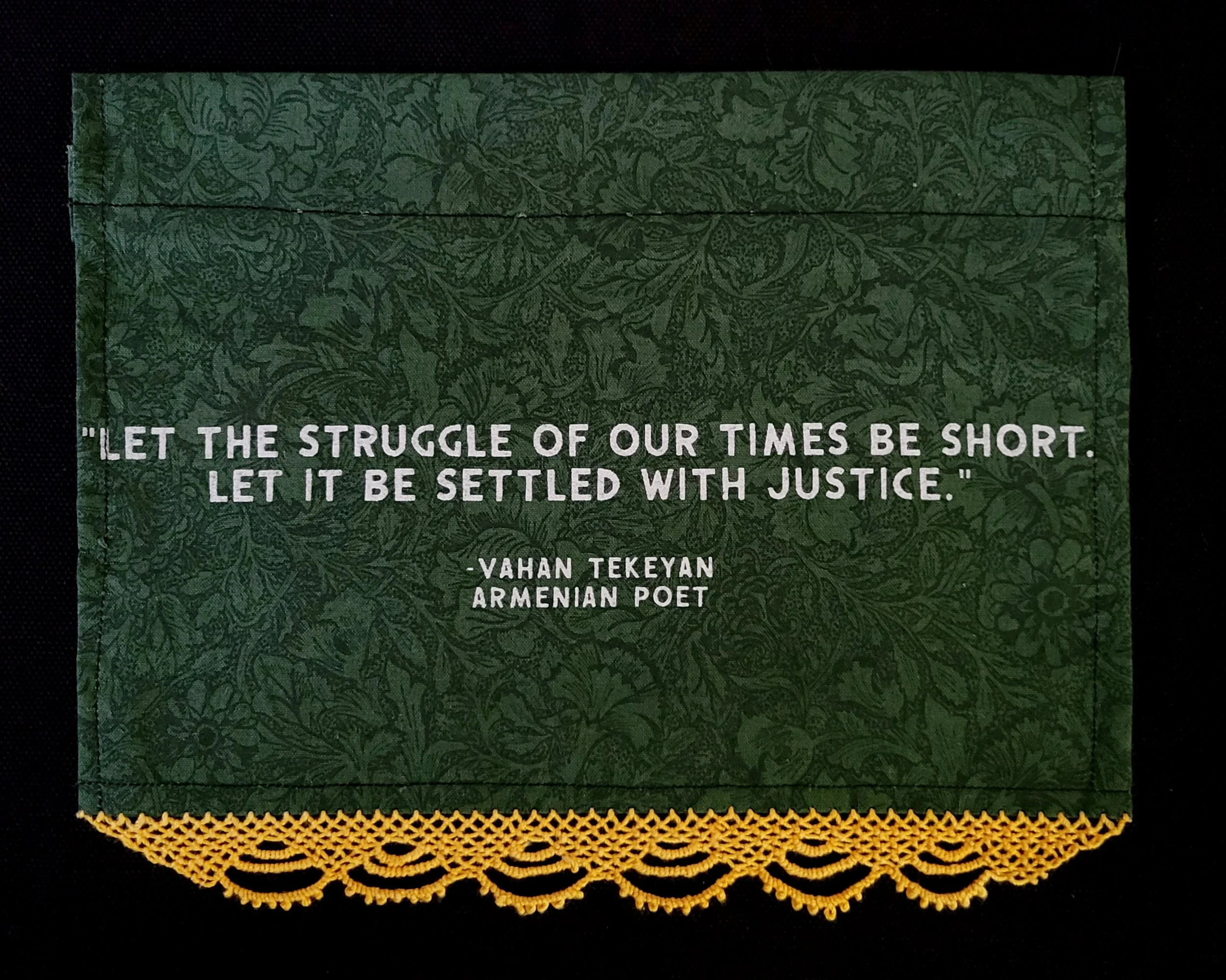 Ali Cat, screenprint with lace trim, cotton fabric and linen thread, Portland, Oregon, 2024. Features a line from Armenian poet Vahan Tekeyan: "Let the struggle of our times be short. Let it be settled with justice." Photo credit: © Ali Cat 2024.