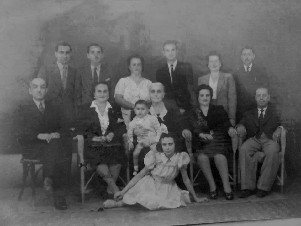 Elise Youssoufian's great-grandmother Arousiag Papazian (née Bodikian, center, holding Elise’s father as a child) surrounded by four of her five daughters (including Elise's grandmother Alice, back row, second from right), sons-in-law (including Elis