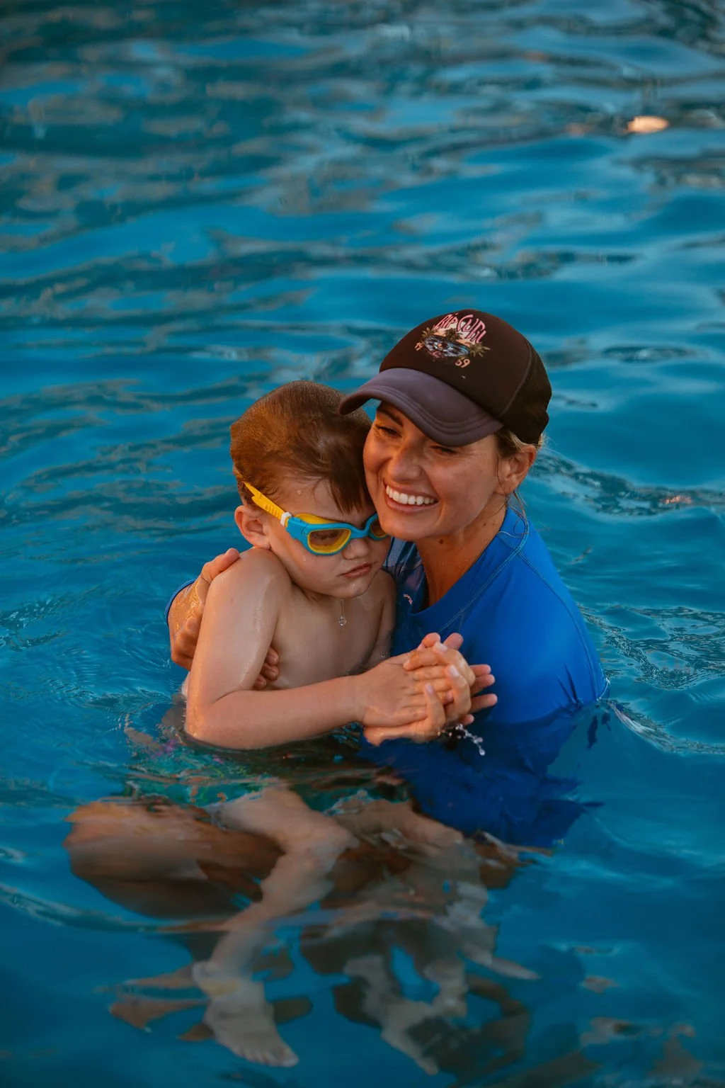 Liz Freeman holding student in pool