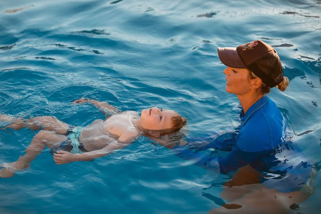 Liz Freeman helping a student learn to float