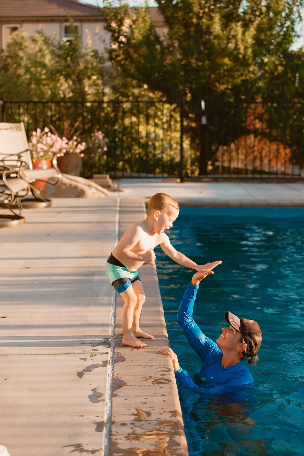 Liz Freeman giving a high five to a boy poolside