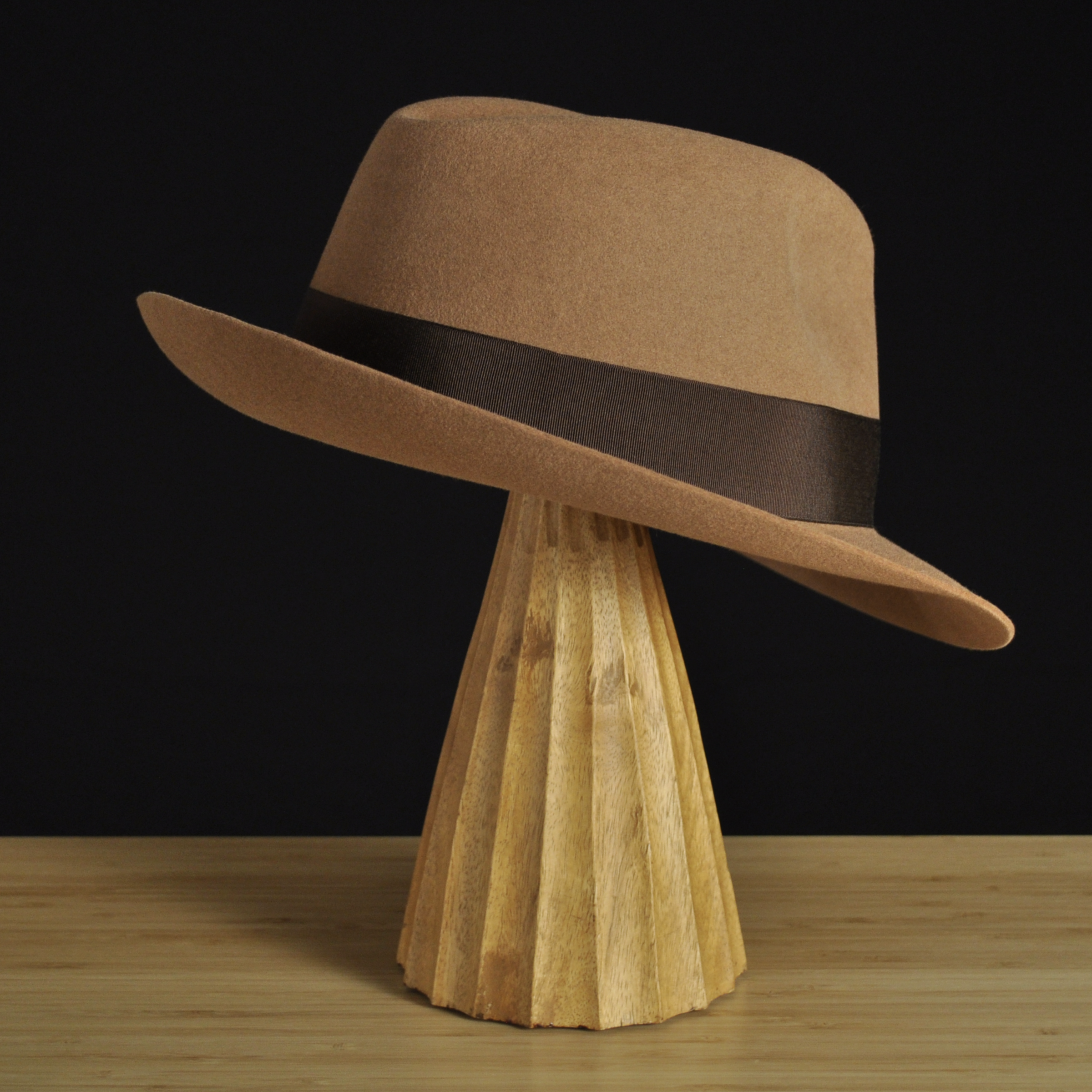 Three-quarter rear right view of The Vendômer tan felt fedora with a softly pinched crown, medium snap brim, and dark brown grosgrain ribbon with classic bow.