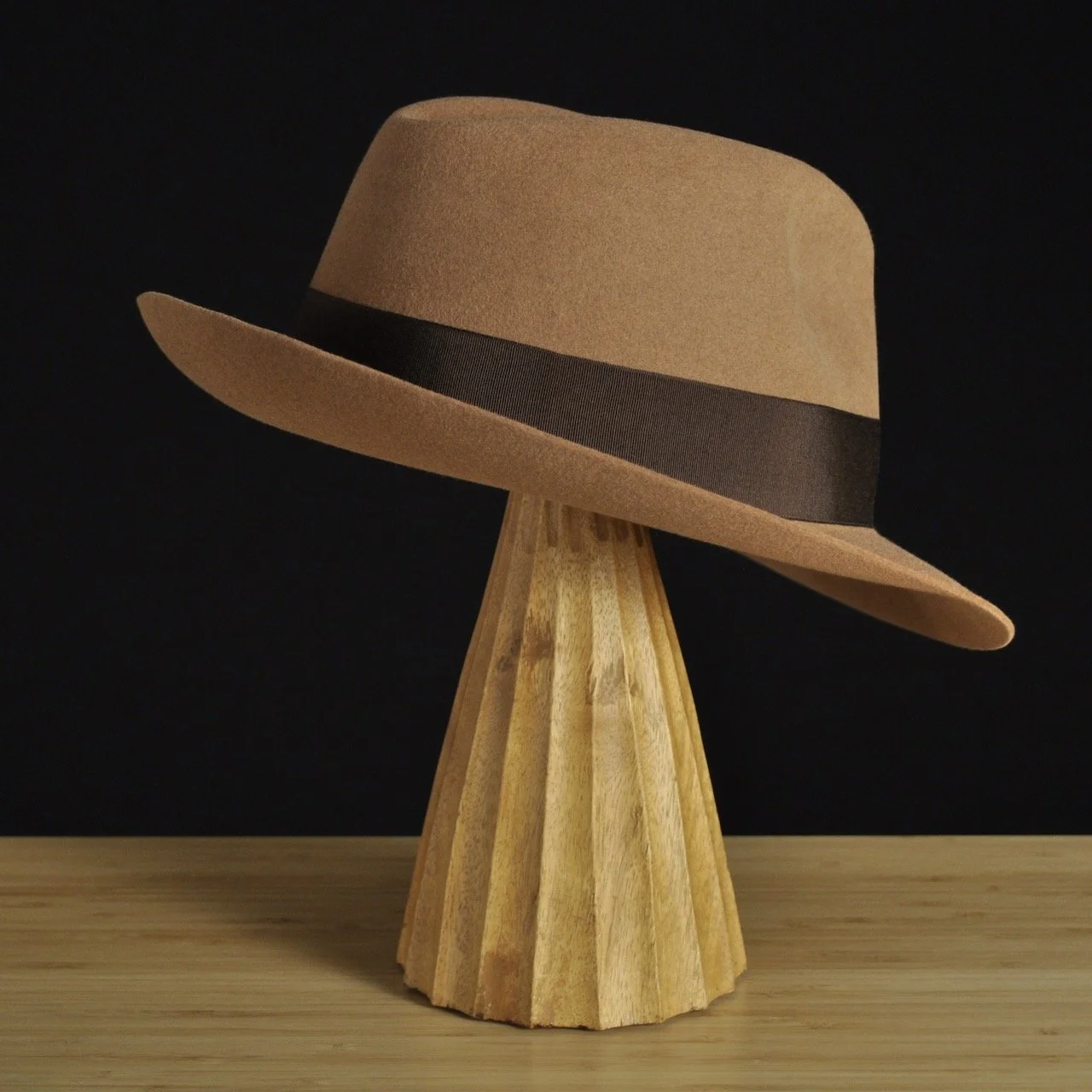 Three-quarter rear right view of The Vendômer tan felt fedora with a softly pinched crown, medium snap brim, and dark brown grosgrain ribbon with classic bow.
