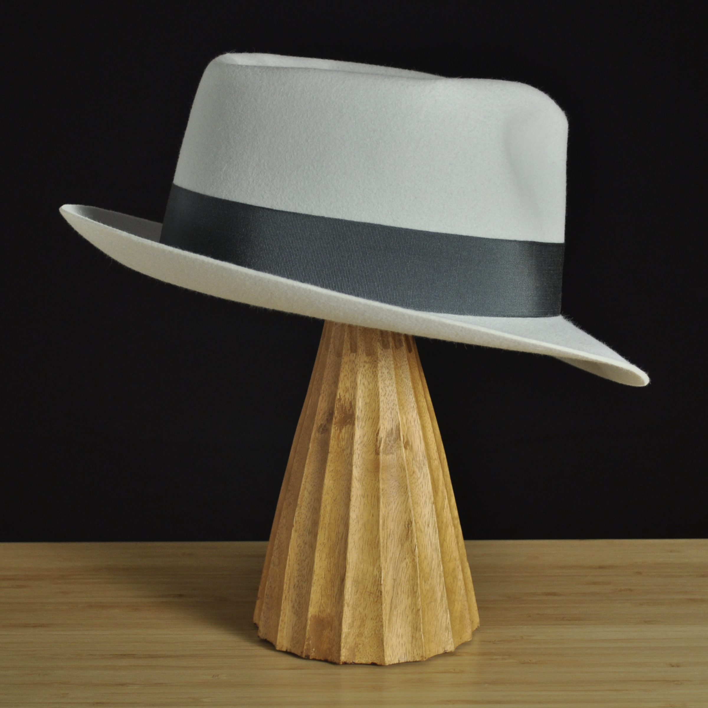 Three-quarter rear right view of The Sunsetter silvermist felt fedora with a softly pinched crown, medium snap brim, and contrasting dark grosgrain ribbon with a modern tie (no bow).
