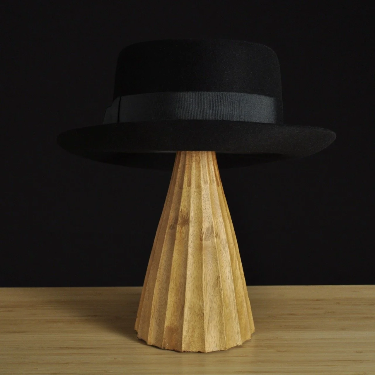 - Back view of The Midtowner black felt fedora with a clean tapered crown, medium snap brim, and matching black grosgrain ribbon with classic bow.