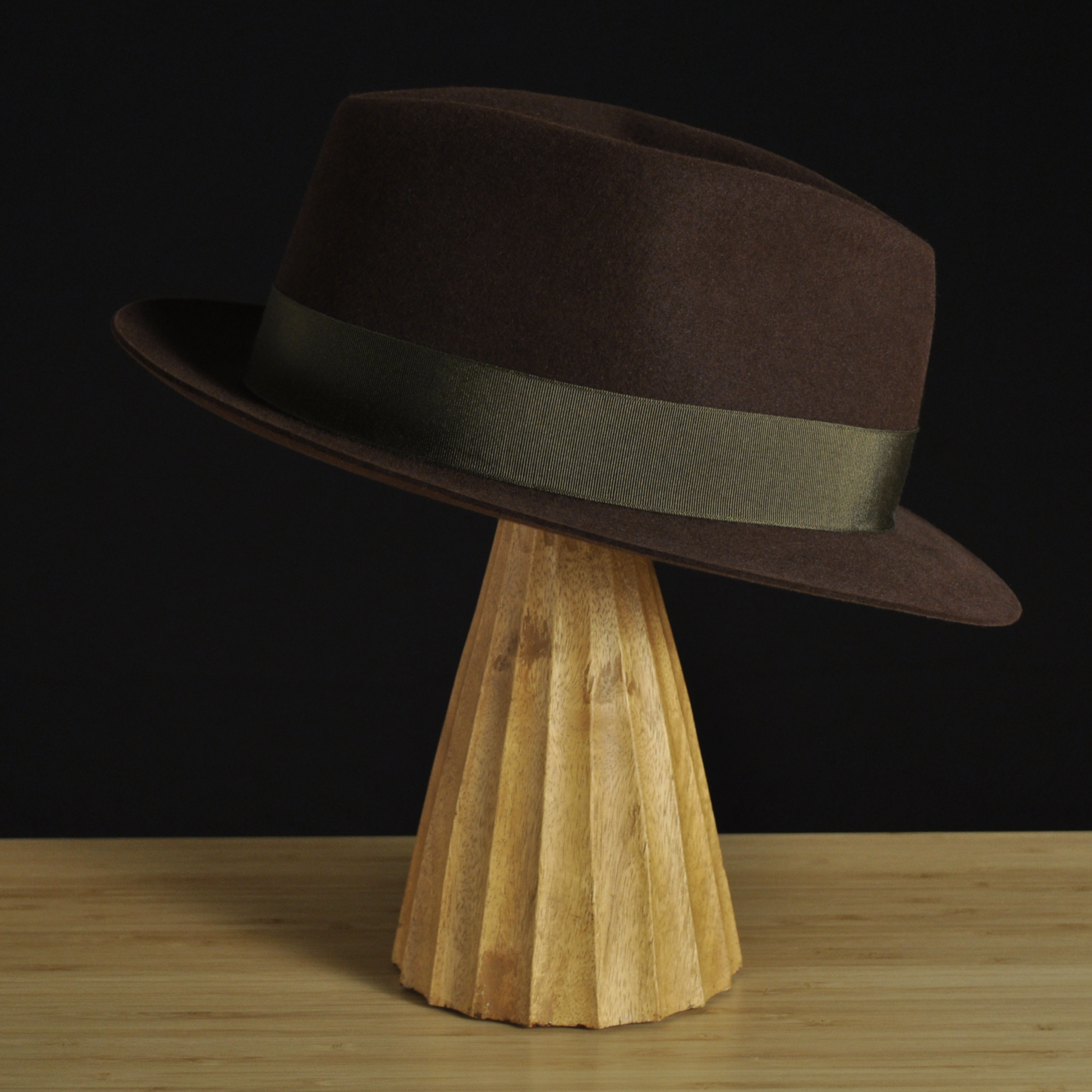 Right view of The Hielander brown felt fedora with a softly pinched crown, medium snap brim, and olive grosgrain ribbon with classic bow.