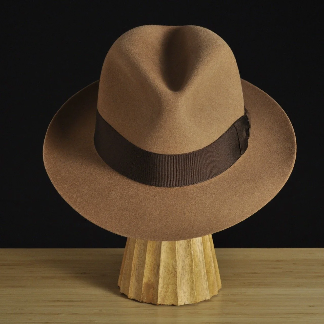 Front view of The Vendômer tan felt fedora with a softly pinched crown, medium snap brim, and dark brown grosgrain ribbon with classic bow.