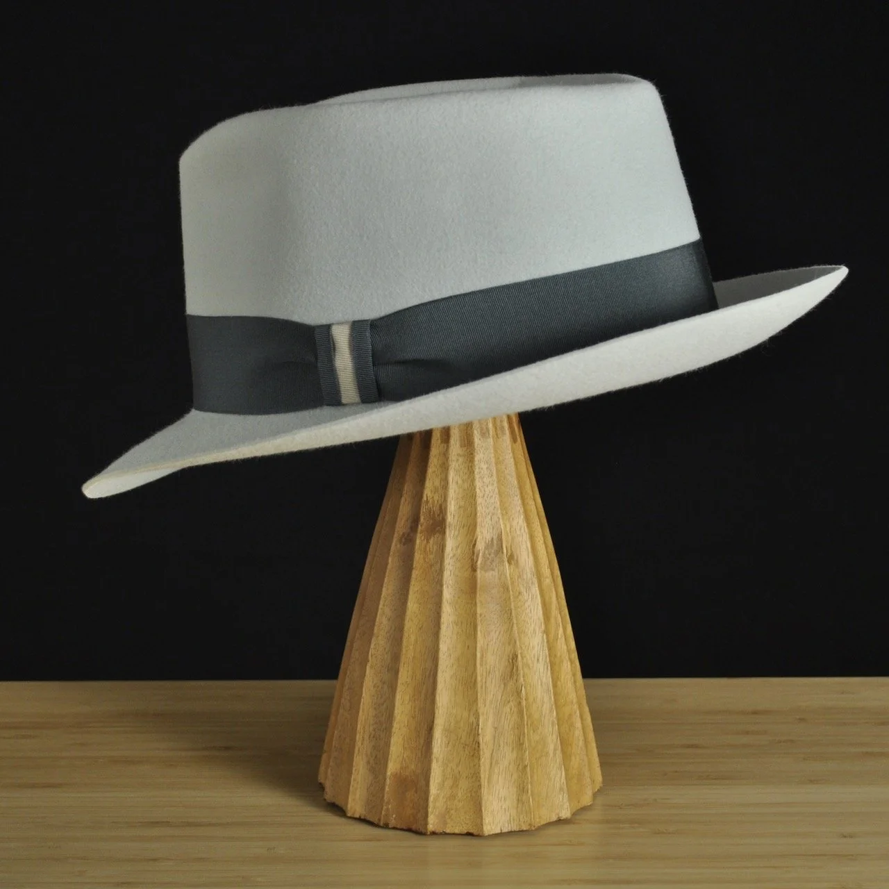 Three-quarter rear left view of The Sunsetter silvermist felt fedora with a softly pinched crown, medium snap brim, and contrasting dark grosgrain ribbon with a modern tie (no bow).