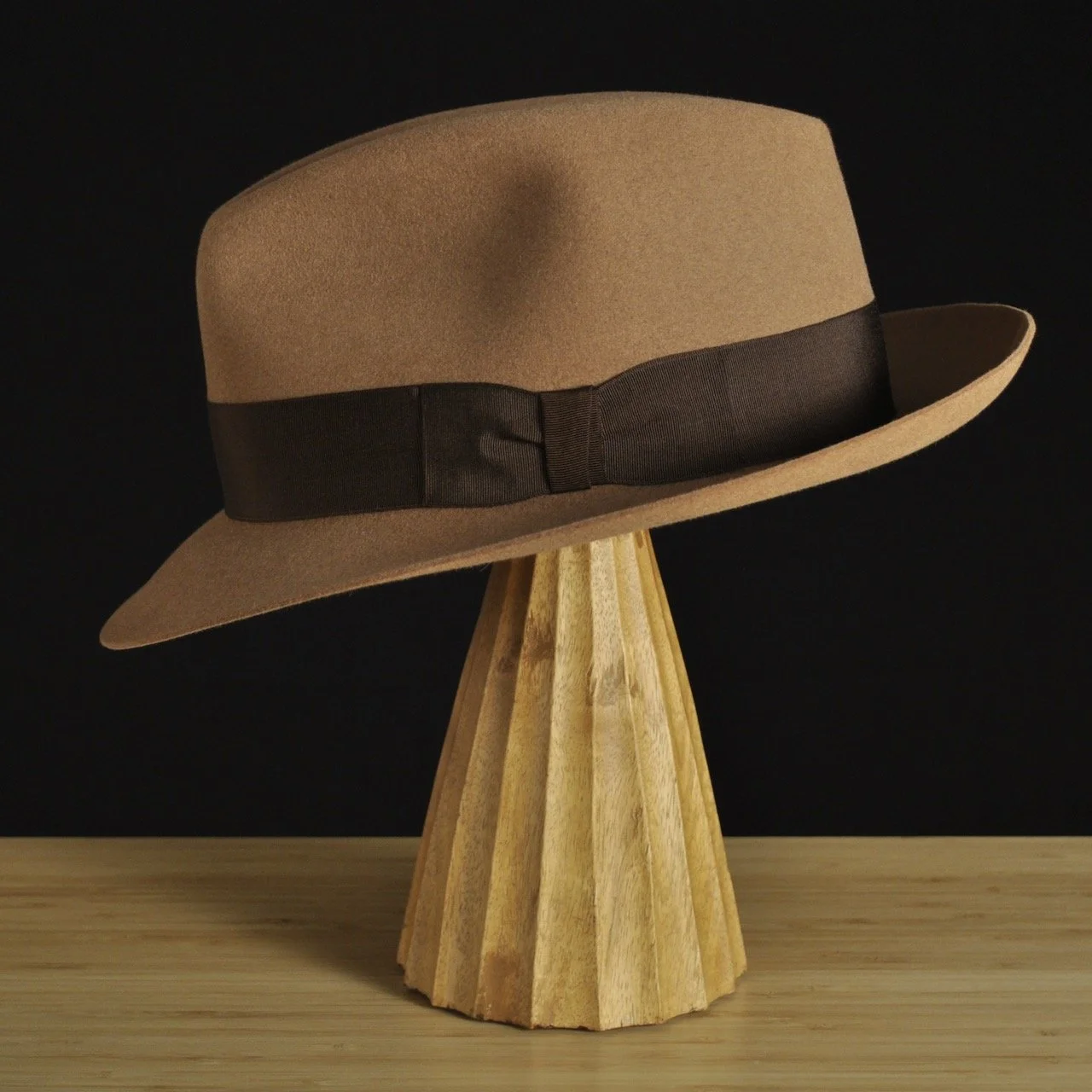 Left view of The Vendômer tan felt fedora with a softly pinched crown, medium snap brim, and dark brown grosgrain ribbon with classic bow.