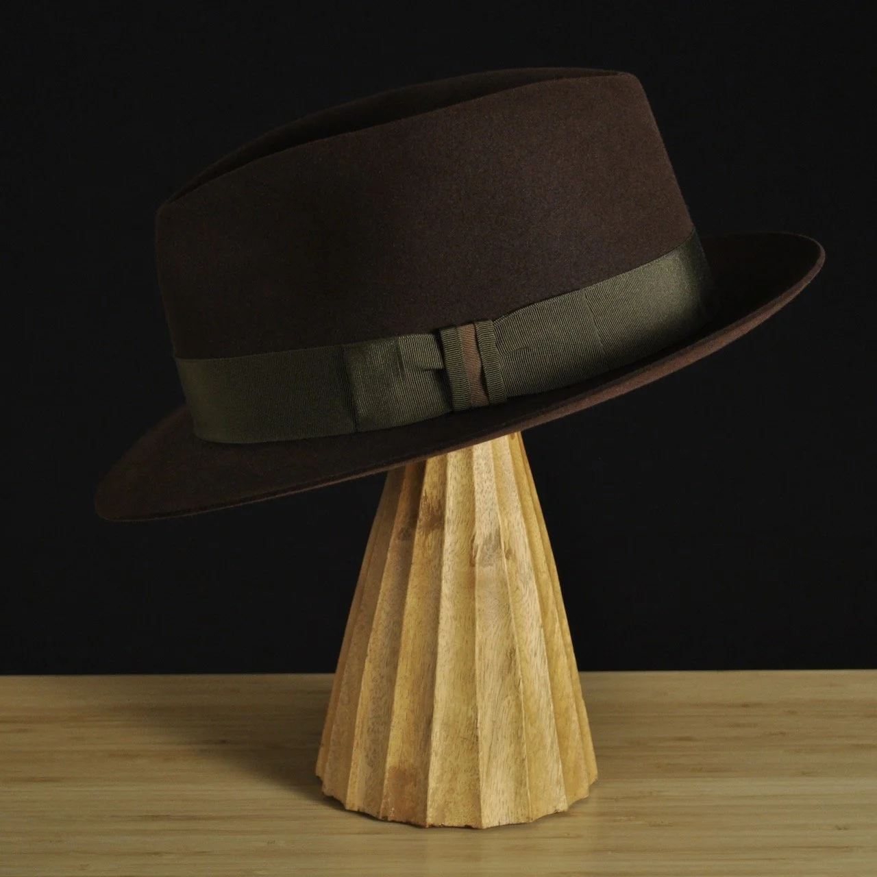 - Left side profile of The Hielander fedora showing the clean crown lines, medium-width brim, and olive grosgrain ribbon detail.