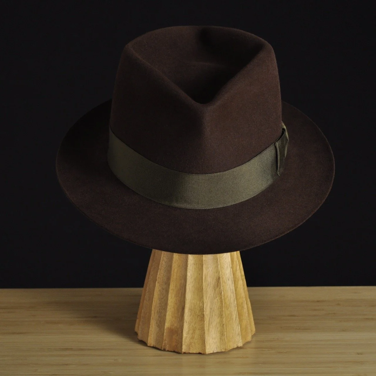 - Front view of The Hielander brown felt fedora with a softly pinched crown, medium snap brim, and olive grosgrain ribbon with classic bow.